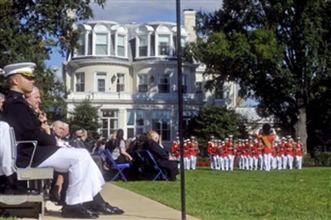 Audience members listen as the United States Marine Corps Drum and Bugle Corps performs during a Passage of Command ceremony at the Marine Barracks, Washington, D.C., Oct. 22, 2010. Marine Corps Gen. James T. Conway relinquished command as commandant of the Marine Corps to Gen. James F. Amos in a ceremony presided over by Defense Secretary Robert M. Gates.