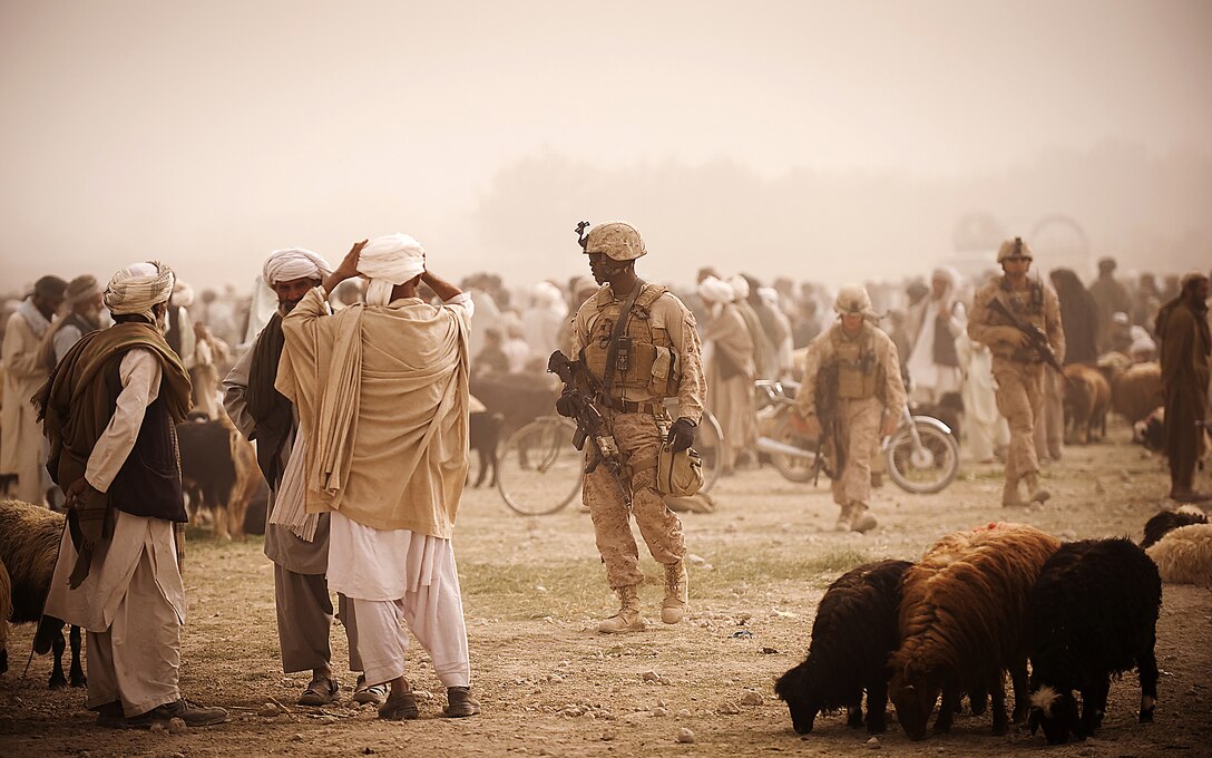 Navy Petty Officer 3rd Class Jadoine Graham, a corpsman with Jump Platoon, 3rd Battalion, 3rd Marine Regiment, provides security while escorting media through the Nawa Bazaar in Helmand province, Afghanistan, Oct. 22, 2010. Jump Platoon’s primary mission is to provide security for the battalion commander and transport him throughout 3/3’s battle space, but the platoon performs a variety of tasks from providing supplementary security and running vehicle checkpoints, to masonry and gardening. (Official Marine Corps photo by Sgt. Mark Fayloga)