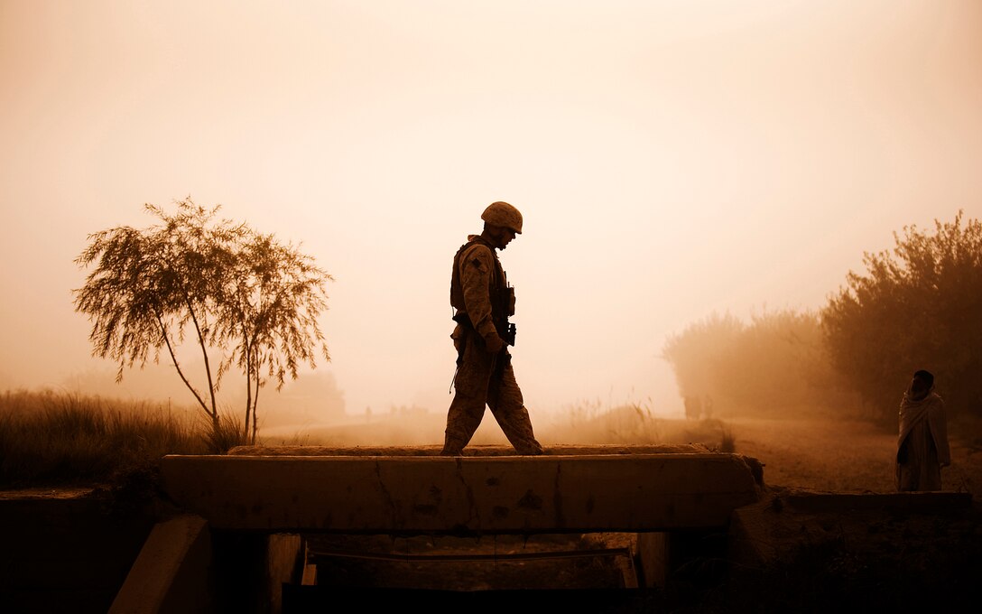 Chief Warrant Officer 2 James Law, the Jump Platoon commander and battalion gunner for 3rd Battalion, 3rd Marine Regiment, walks across a bridge in Nawa, Helmand province, Afghanistan, while providing security during a media escort Oct. 22, 2010. Jump Platoon’s primary mission is to provide security for the battalion commander and transport him throughout 3/3’s battle space, but the platoon performs a variety of tasks from providing supplementary security and running vehicle checkpoints, to masonry and gardening. Law is from Portland, Ore.