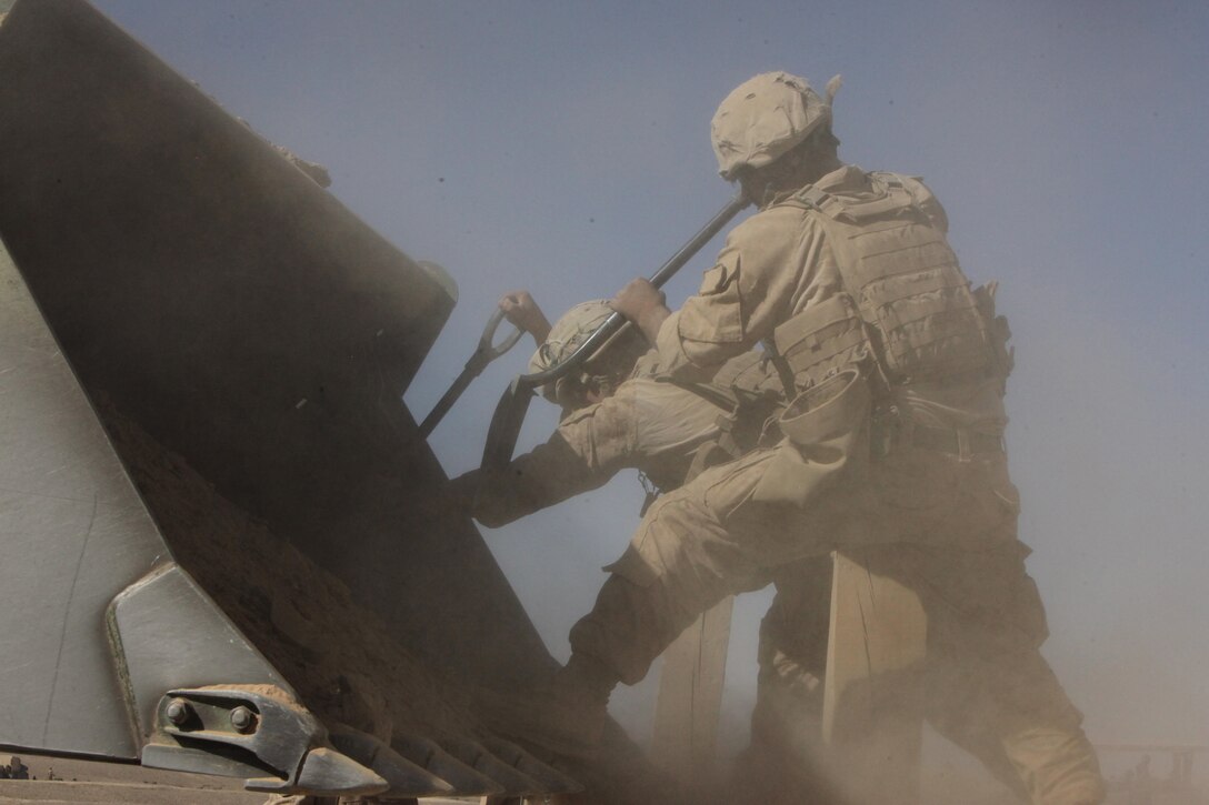 Marines from Charlie Company, Combat Logistics Battalion 2, 1st Marine Logistics Group (Forward) fill a Hesco barrier while building Patrol Base Demazong in Helmand province, Afghanistan, Oct. 22. Marines from CLB-2, 1st MLG (FWD) constructed the patrol base overlooking the village of Demazong, and hope the presence of International Security Assistance Forces will attempt to halt the flow of illegal items coming in from Iran and Pakistan. While Marines built the Patrol Base, Georgian soldiers conducted foot patrols in the area, and Afghan National Army soldiers set up vehicle checkpoints along the road.