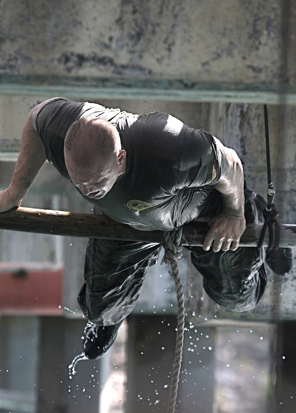 A team leader with 2nd Platoon, Force Reconnaissance Company, II Marine Expeditionary Force, demonstrates how to properly navigate through an obstacle Oct. 22, 2010. A combination of jungle terrain, mountains, the ocean and the locations of Dutch marine bases make the island of Curacao an optimal place to conduct amphibious operations training with Dutch marines.