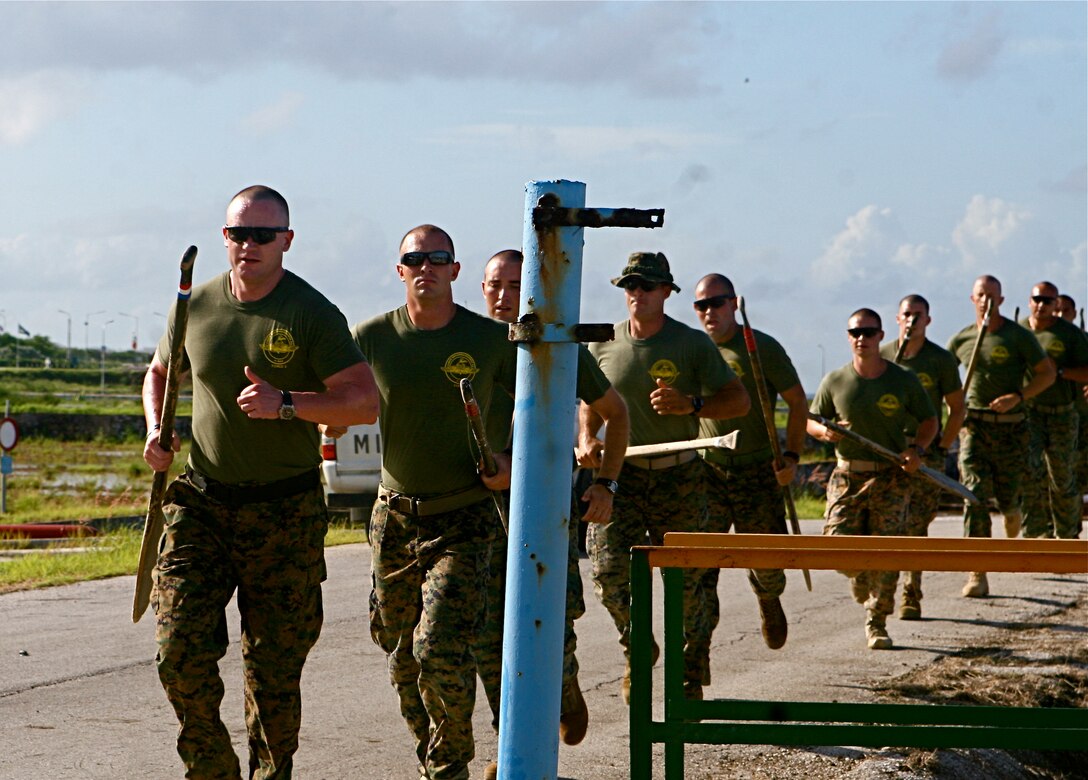 Marines of 2nd Platoon, Force Reconnaissance Company, II Marine Expeditionary Force, participate in a boots and utilities run prior to doing the Dutch Water Obstacle Course, Oct. 22, 2010. Reconnaissance Marines carry their paddles with them throughout most physical training they undergo.