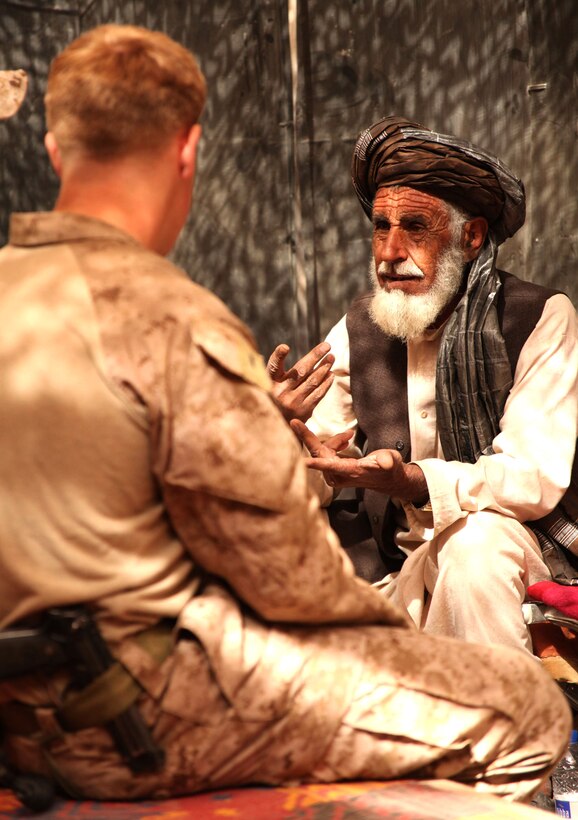 U.S. Marine First Lt. Taylor Williams, platoon commander for Weapons Platoon, Fox Company, 2nd Battalion, 6th Marine Regiment, speaks with a village elder about establishing a neighborhood watch under the Interim Security Critical Infrastructure program, in Marjah, Oct. 23, 2010. “When we first came in, we took contact every day for about the first two and-a-half months. The conditions were not stable enough for a [citizen-run] security program in the northern part of our area,” said Williams, 24, from Raleigh, N.C. “Now it seems like the locals are ready to sustain their own type of police force here. The security situation has changed significantly down here.”