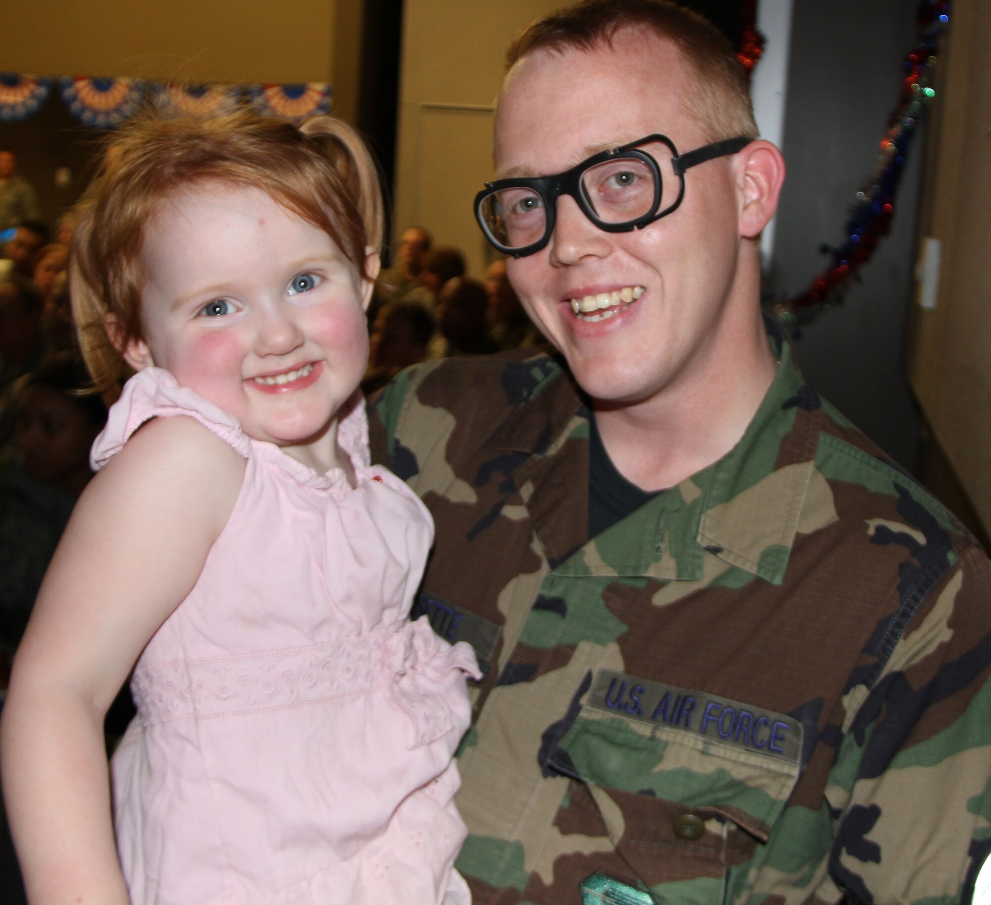 Tech. Sgt. Thomas Dissette and daughter following a briefing for returning ORI deployers.  Sergeant Dissette and some 200 fellow 932nd Airlift Wing reservists just completed a successful week-long readiness inspection.  (U.S. Air Force photo/Tech. Sgt. Dan Oliver)