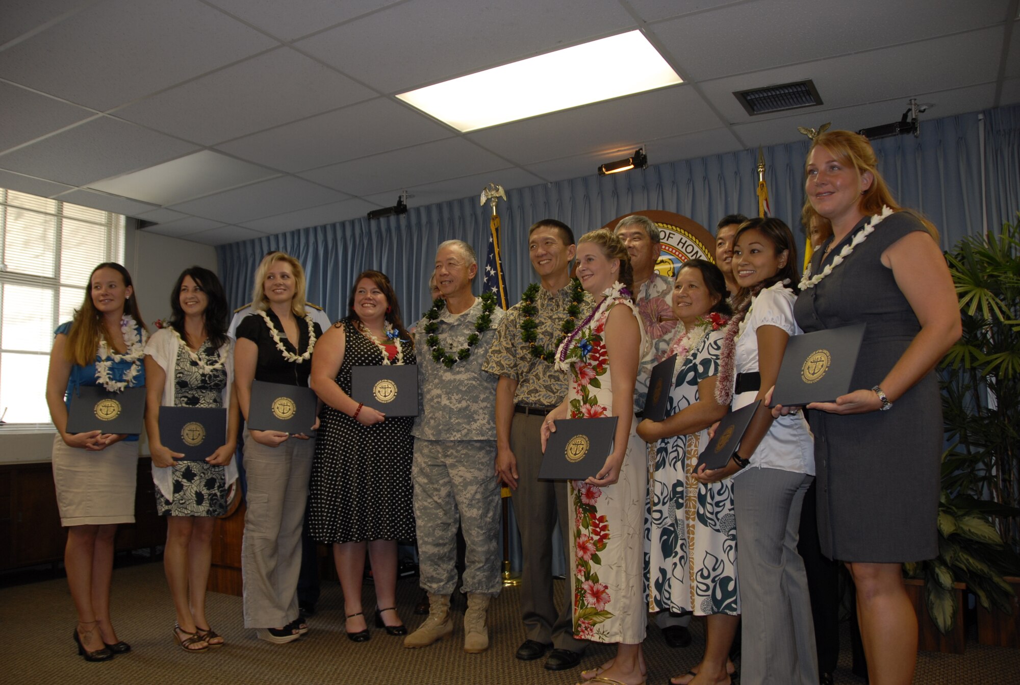 Outstanding key spouses from different military branches and commands were honored by the Navy League for their volunteer efforts Oct. 15, 2010 at City Hall, Honolulu, Hawaii. Each spouse received a $1,000 scholarship check and certificates of appreciation and coins from military leaders in attendance. (U.S. Air Force photo/Capt. Allison Stephens)