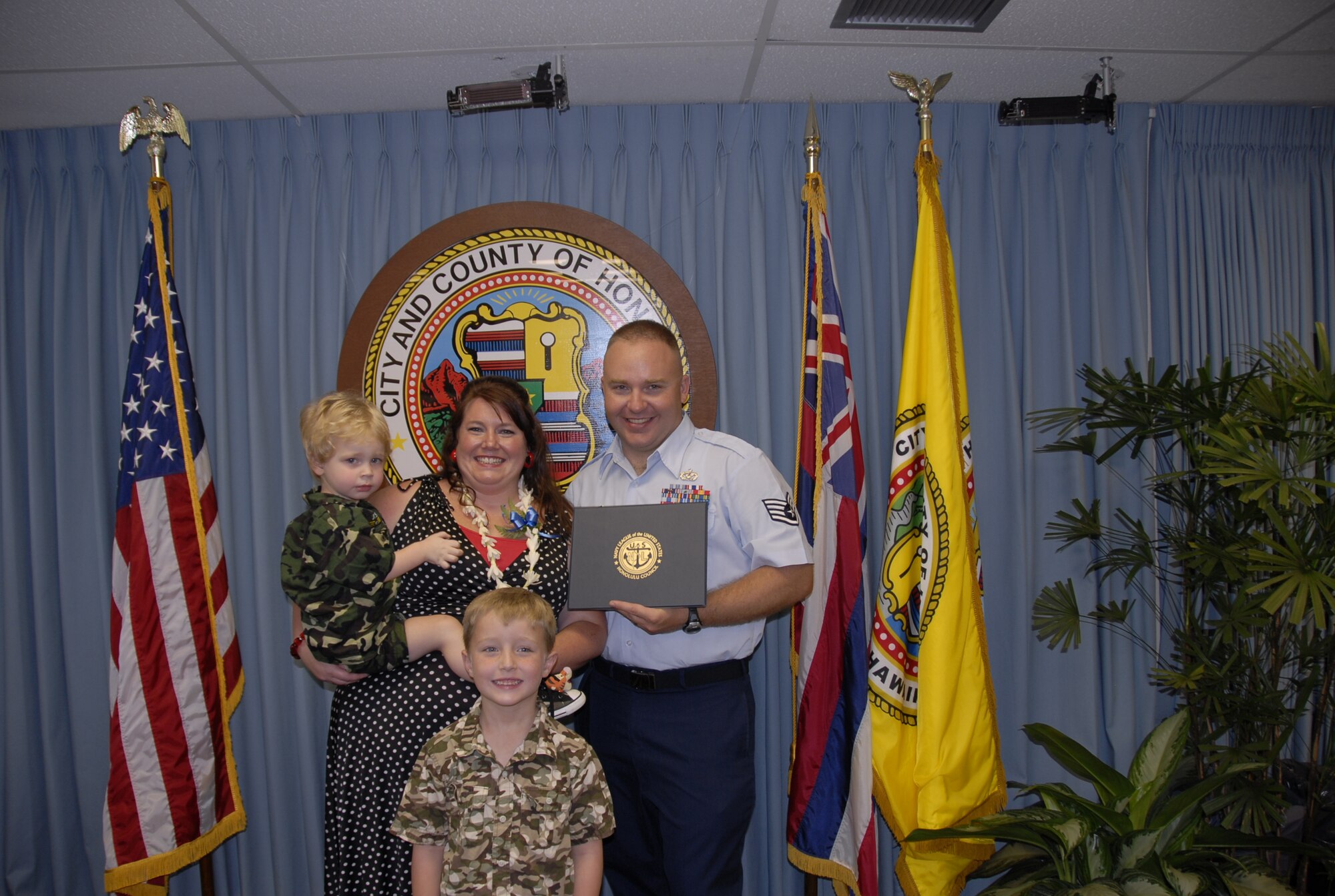 Melissa McGuire, Navy League Outstanding Key Spouse Award recipient, poses with her family, Staff Sgt Lawrence McGuire, Conner, age two, and Aidan, age 6, Oct. 15, 2010 at City Hall, Honolulu, Hawaii.  A key spouse from each branch of the military services was honored by the Navy League for their volunteer efforts with families of deployed service members. (U.S. Air Force photo/Capt. Allison Stephens)  