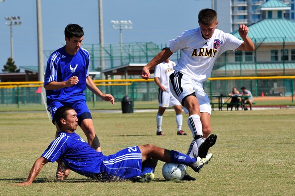 U.S. Air Force Capt. Jason Belvill slide tackles U.S. Army Sgt. Tyler Stratford during an Armed Forces Men's Soccer Championship Semifinal match against the U.S. Army at Morgan Sports Complex, Destin, Fla., Oct. 23, 2010. The Armed Forces Championships are conducted by the Armed Forces Sports council for the purpose of promoting, understanding, goodwill, and competition among the Armed Services. (DoD Photo by Staff Sgt. Stephanie Jacobs/RELEASED)