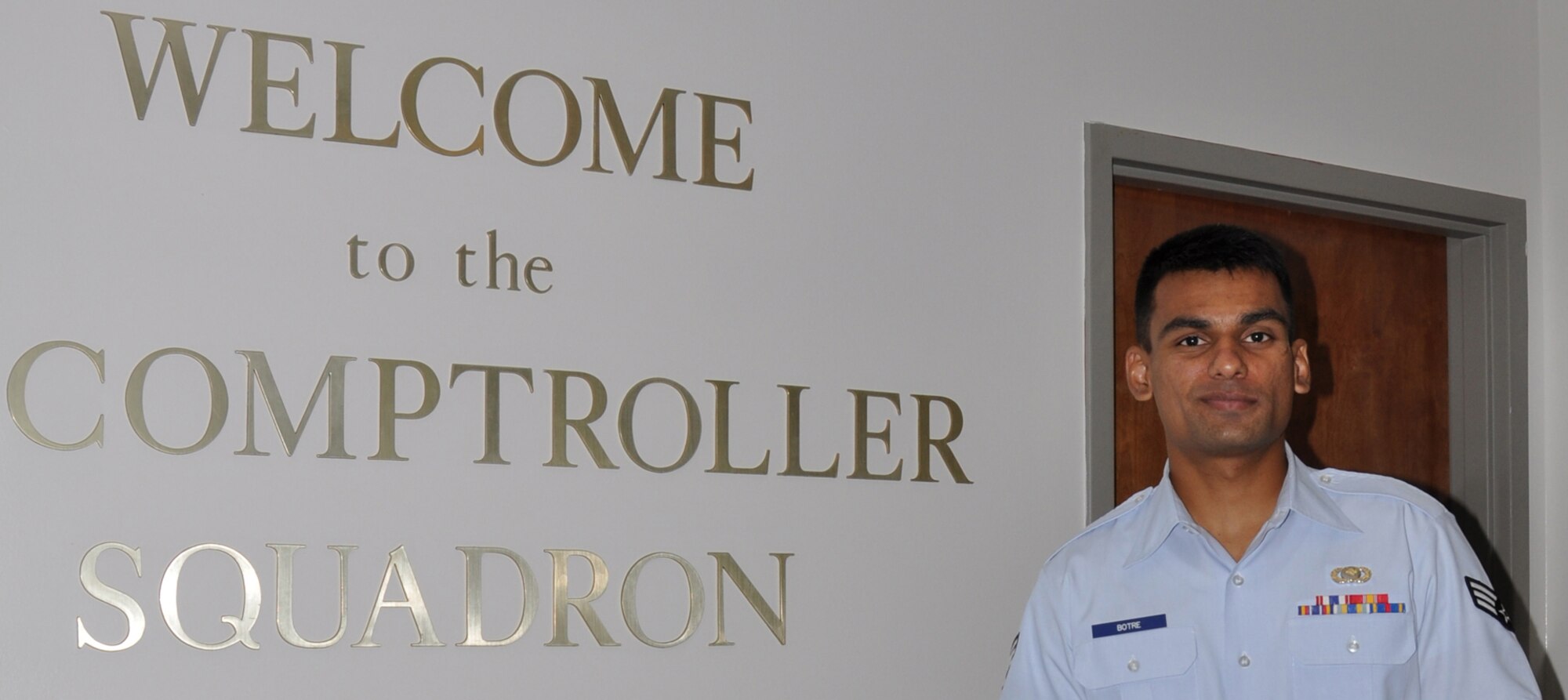 Senior Airman Akshay Botre, 1st Special Operations Comptroller Squadron financial analysis journeyman, poses in front of the 1st SOCPTS sign at the 1st Special Operations Wing Headquarters building at Hurlburt Field, Fla., Oct. 19, 2010. Airman Botre was selected for this week's Tip of the Spear spotlight. (DoD photo by U.S. Air Force Senior Airman Sheila deVera)