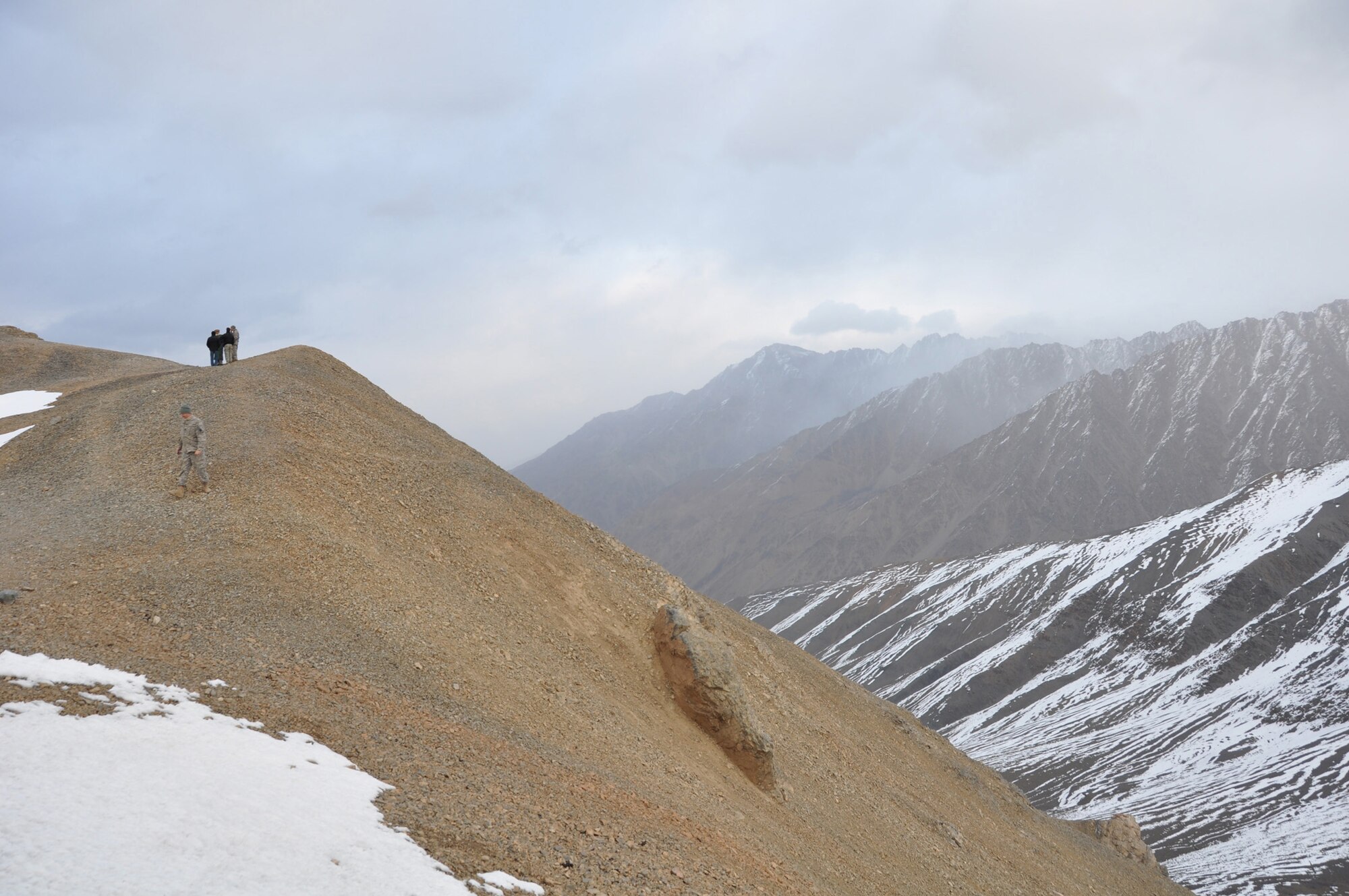 PANJSHIR PROVINCE, Afghanistan ? Members of the Panjshir Provincial Reconstruction Team civil engineering team overlook Anjuman Pass on the border of the province Oct. 13. The engineers surveyed a 15-kilometer section of road that once complete, will connect the province to Badakshan, enabling the possibility of increased commerce and travel. (U.S. Air Force Photo by 1st Lt. Holly Hess, Panjshir PRT Public Affairs)