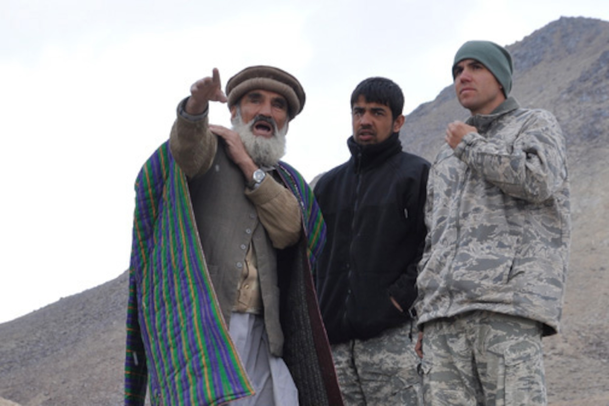 PANJSHIR PROVINCE, Afghanistan ? U.S Air Force Capt. Phillip Baker, Panjshir Provincial Reconstruction Team lead civil engineer and San Antonio native, discusses road construction with Kalender Big, a former Mujahedeen general who served under Ahmad Shah Massoud, national hero of Afghanistan. The engineers surveyed a 15-kilometer section of road Oct. 13, that once complete, will connect the province to Badakshan, enabling the possibility of increased commerce and travel. (U.S. Air Force Photo by 1st Lt. Holly Hess, Panjshir PRT Public Affairs)