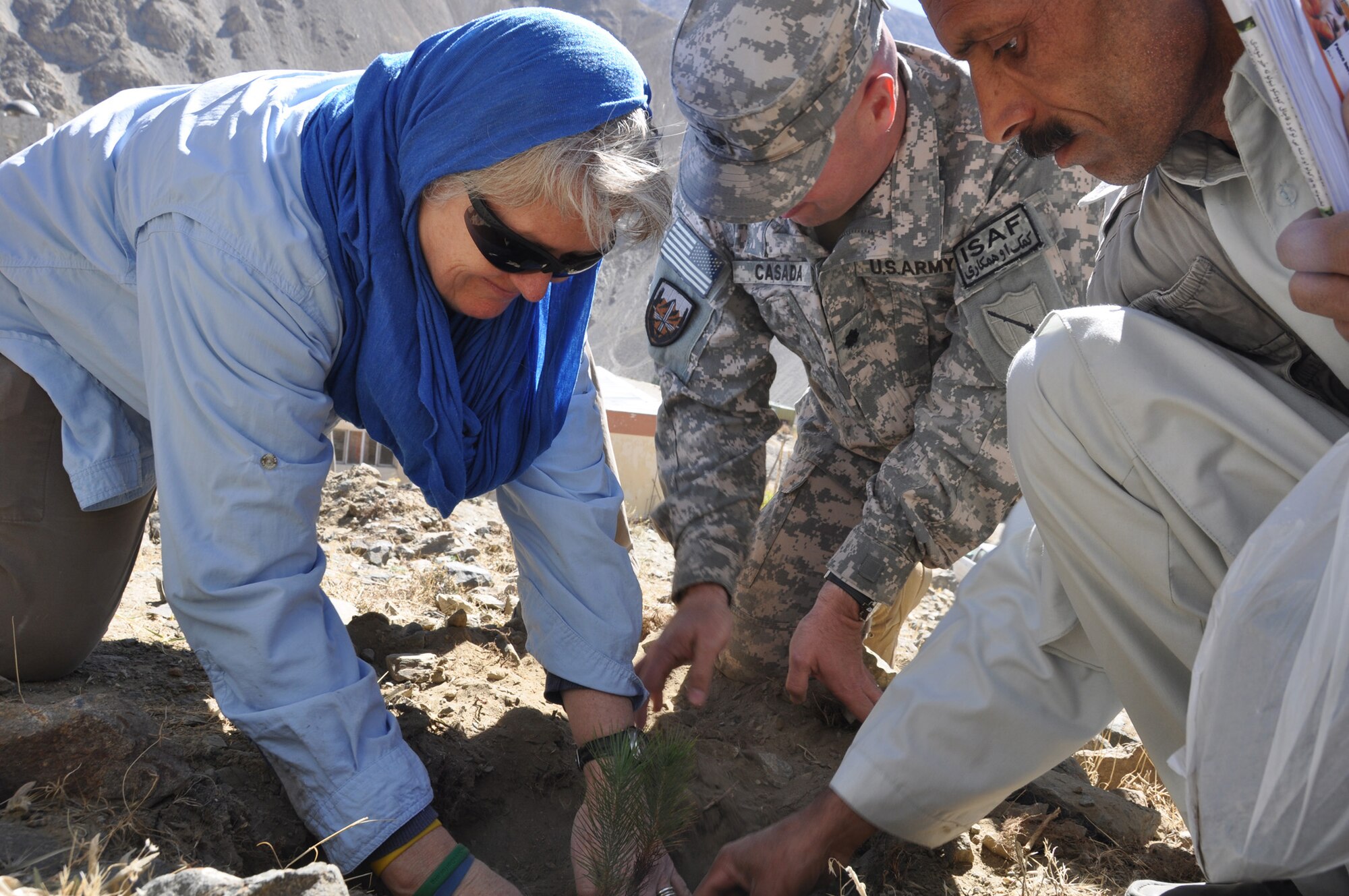 Elizabeth Smithwick, U.S. Agency for International Development lead field officer at Panjshir Provincial Reconstruction Team and acting PRT director; and U.S. Army Lt. Col. Jeffrey Casada, Kentucky National Guard Agribusiness Development Team leader with Panjshir PRT and London, Ky., native, plant a seedling during the groundbreaking ceremony for the Panjshir greenbelt project Oct. 10. 35,000 trees will be planted throughout the province as part of a reforestation project over the next three months. (U.S. Air Force Photo by 1st Lt. Holly Hess, Panjshir PRT Public Affairs)