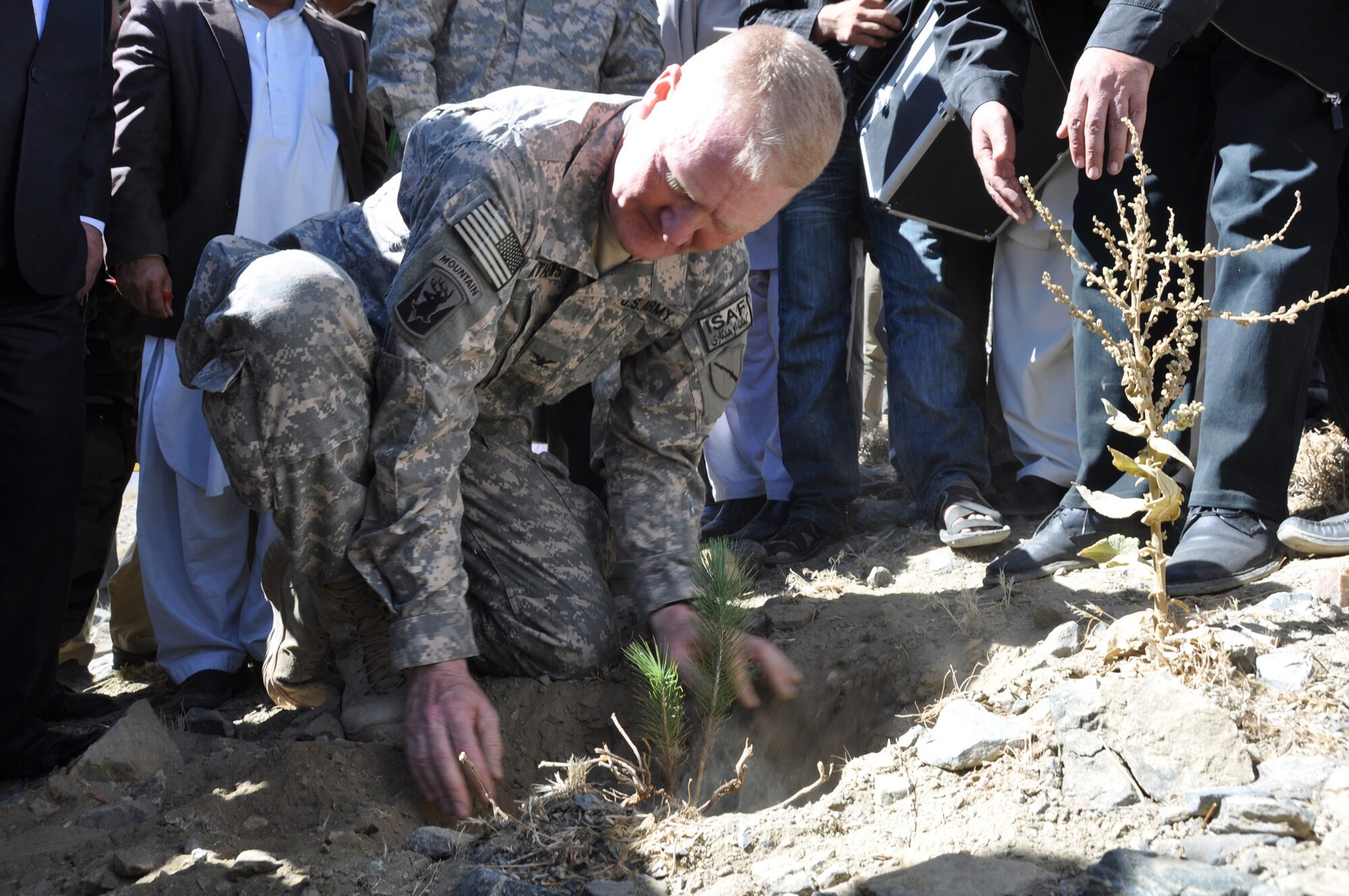 U.S. Army Col. Hunter Mathews, Kentucky Agribusiness Development Team II commander from Lexington, Ky., plants a seedling during the groundbreaking ceremony for the Panjshir greenbelt project Oct. 10. 35,000 trees will be planted throughout the province as part of a reforestation project over the next three months. (U.S. Air Force Photo by 1st Lt. Holly Hess, Panjshir PRT Public Affairs)