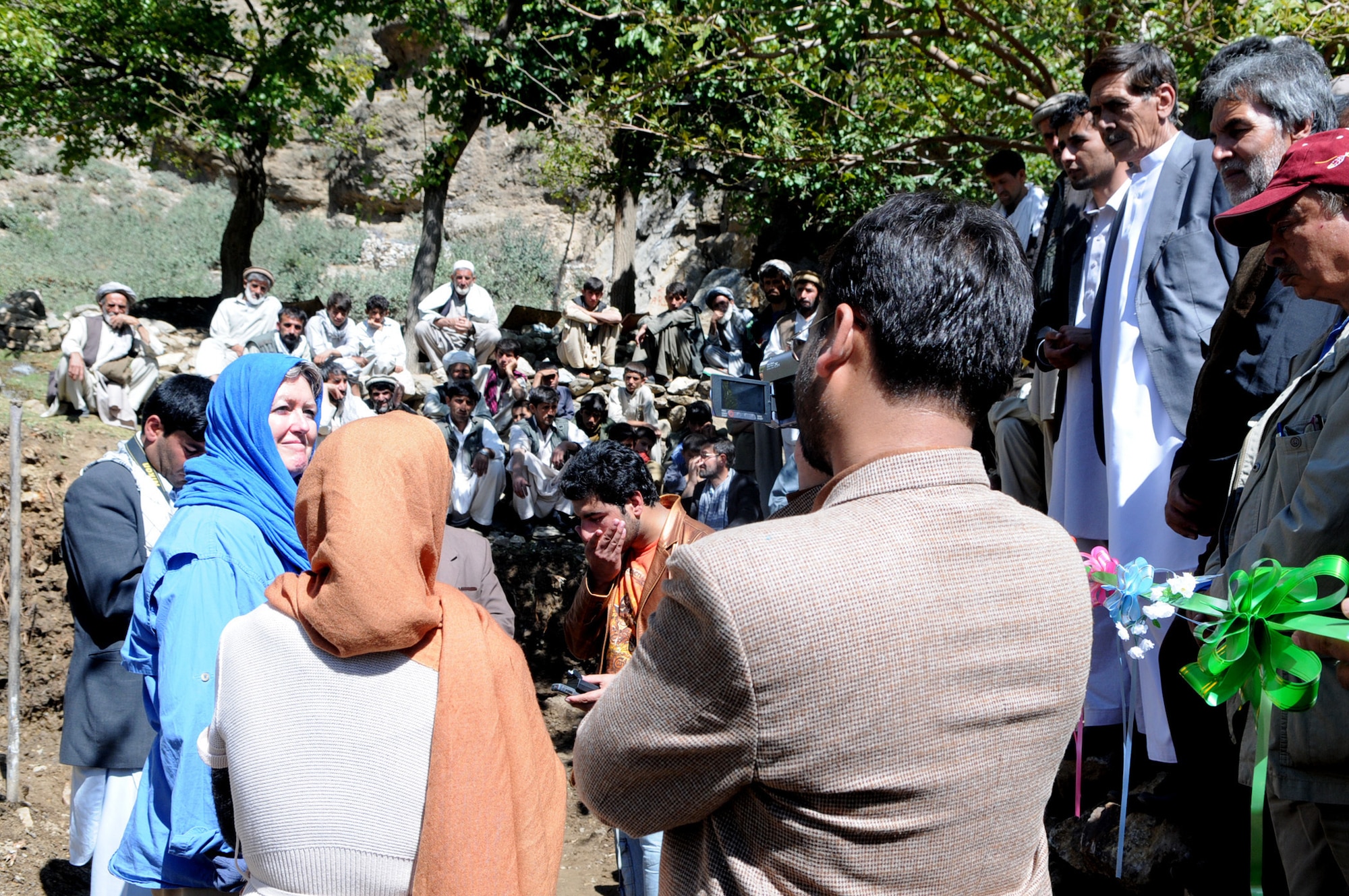 Elizabeth Smithwick, U.S. Agency for International Development lead field officer at Panjshir Provincial Reconstruction Team and acting Panjshir PRT director, speaks to locals who gathered at a ribbon-cutting ceremony for a Afghanistan Sustainable Water Supply and Sanitation water reservoir.  The SWSS project seeks to increase access to potable water and sanitation services in poor communities, decrease the incidence of water-related diseases through household hygiene interventions, and improve the sustainable management of potable water quality and quantity in project-assisted communities.  (USAF photo by: Tech. Sgt. Sean Mateo White, Panjshir PRT Photographer)