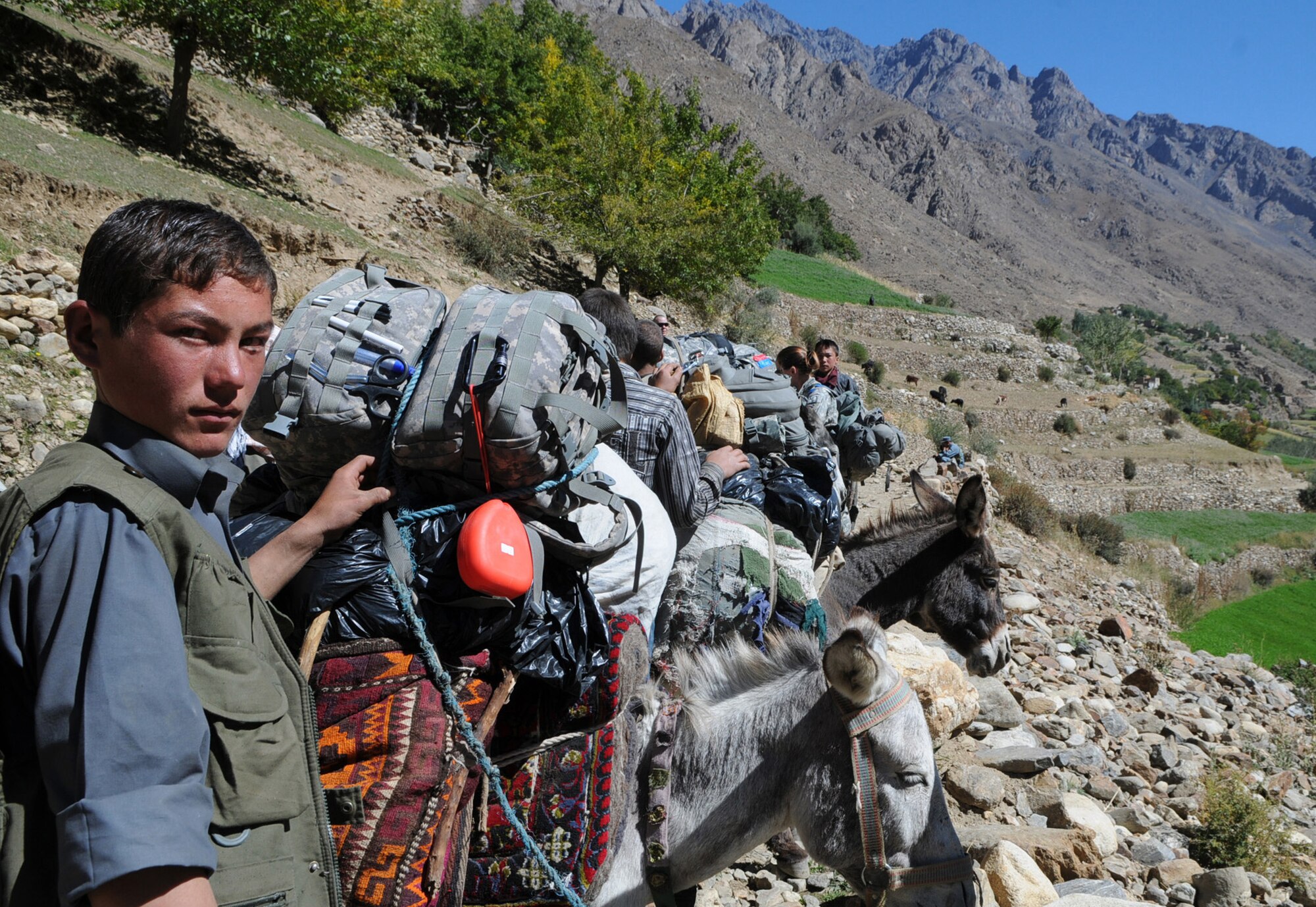 PANJSHIR PROVINCE, Afghanistan ? Several locals from the remote village of Astana in the Dara District assist members of the Panjshir Provincial Reconstruction Team move supplies, Oct. 6.  Donkeys were used to deliver humanitarian aid 12 kilometers to the village.  Members of Panjshir PRT hiked to the village to deliver winter coats and to talk to village elders about any other issues the village may be experiencing.  Astana is only accesible by foot during the summer months and isn?t reachable during the winter due to the large amount of snow the village receives.  (USAF Photo by: Tech Sgt Sean Mateo White, PRT Panjshir photographer)(released)