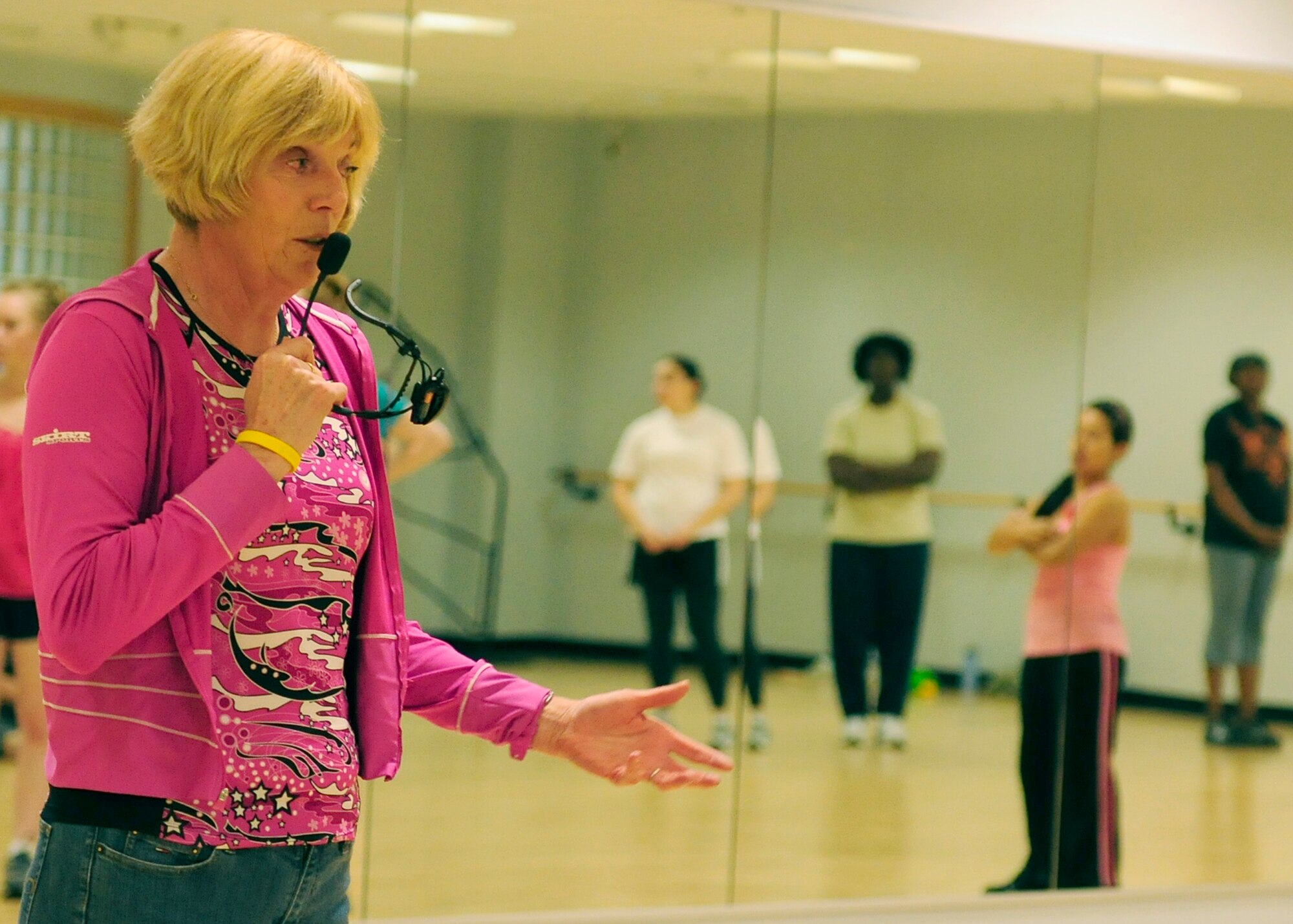 ROYAL AIR FORCE LAKENHEATH, England - Jackie Riley, RAF Lakenheath Fitness Center personal trainer and breast cancer survivor, speaks to cardio kick-boxing participants at the fitness center on Oct. 19. Participants were invited to wear pink work-out attire in honor of Breast Cancer Awareness Month. (U.S. Air Force photo/Airman 1st Class Tiffany M. Deuel)