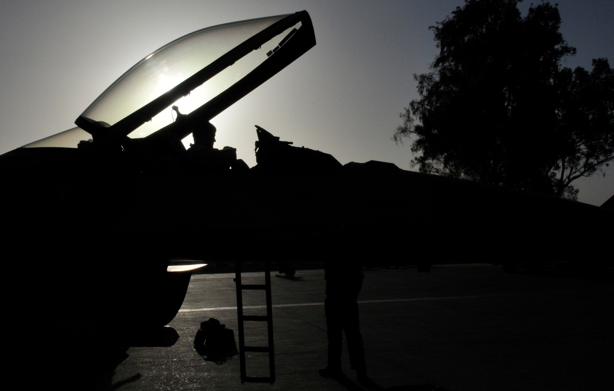 Staff Sgt. Joel Loranger, 13th Expeditionary Aircraft Maintenance Unit crew chief, waits for Capt. Ryan Busbey, 13th Expeditionary Fighter Squadron pilot, to descend from the cockpit of an F-16 Fighting Falcon after a mission Oct. 19, 2010, Joint Base Balad, Iraq. The F-16 Fighting Falcon is a compact, multi-role fighter aircraft. It provides a relatively low-cost, high-performance weapon system for the U.S. and allied nations. Sergeant Loranger is a native of Boise, Idaho. Captain Busbey is a native of De Berry, Texas, and both are deployed from Misawa Air Base, Japan. (U.S. Air Force photo/Tech. Sgt. Phillip Butterfield)