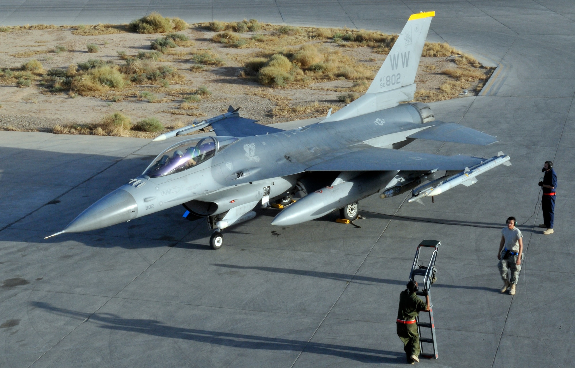 Airmen of the 13th Expeditionary Aircraft Maintenance Unit ground crew prepare to shut down and assist the pilot with stepping down from an F-16 Fighting Falcon after a mission Oct. 19, 2010, Joint Base Balad, Iraq. Ground crews usually consist of a crew chief, who communicates with the pilot on aircraft shutdown procedures, and a fire guard who helps chalk the aircraft’s wheels and stands by with a fire extinguisher in case of a mishap. (U.S. Air Force photo/Tech. Sgt. Phillip Butterfield)