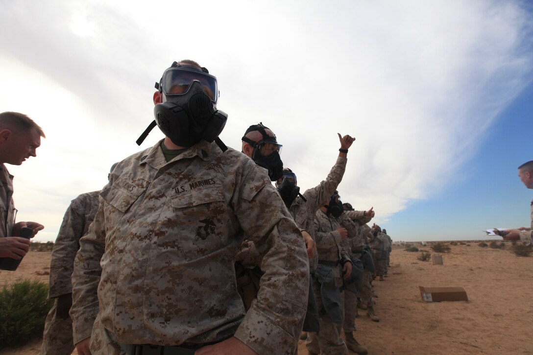 Staff Sgt. Jason Jones, an assistant radio chief with Headquarters Company, Regimental Combat Team 8, receives a  gear inspection prior to entering the gas chamber on Oct. 23, during a deployment for training exercise at Camp P111 aboard Marine Corps Air Station Yuma, Ariz.