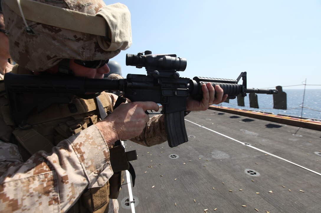 Master Sgt. Christopher A. Matt, combat camera chief with Command Element, 26th Marine Expeditionary Unit, fires at targets while conducting pivot drills during a live-fire exercise aboard USS Kearsarge, Oct. 24, 2010. 26th MEU is currently embarked aboard the ships of Kearsarge Amphibious Ready Group and conducting training in the 5th Fleet area of responsibility. (Official USMC Photo by Lance Cpl. Tammy K. Hineline/ Released)