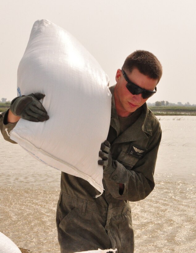 Cpl. Derek Braaskma delivers flood relief supplies to a Humanitarian Assistance site near Pano Aqil Cantonment, Oct. 24, 2010. The U.S. Marine Corps’ 15th and 26th Marine Expeditionary Units have been operating CH-46 Sea Knight and CH-53 Super Stallion helicopters in the Sindh province since early September bringing relief supplies to those in need. Since Aug. 5, U.S. military helicopters have transported more than 12 million pounds of supplies. (Official U.S. Air Force photo by SSgt Kali Gradishar)(Released)
