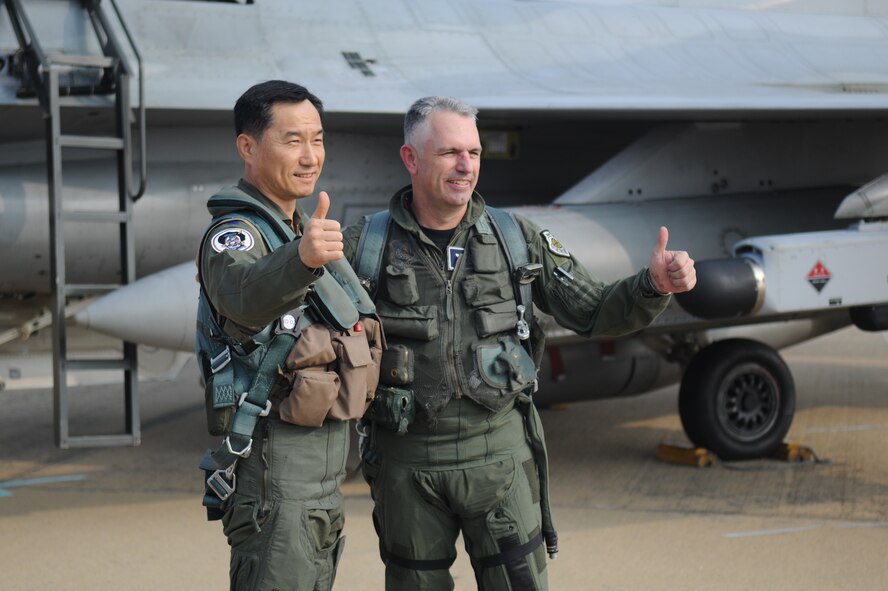 Republic of Korea Air Force Brig. Gen. Jung Jaebu, Air Force Operations Command vice commander, left, and Brig. Gen. Scott Dennis, 7th Air Force vice commander, give “two thumbs up” following a cross-command flight Oct. 21 during exercise Max Thunder 10-02 at Kwangju Air Base, ROK. General Jaebu flew in a U.S. Air Force F-16 Fighting Falcon while General Dennis flew in an ROK Air Force F-16 as a show of solidarity of the ROK-US alliance. (U.S. Air Force photo/Master Sgt. Jason Wilkerson)