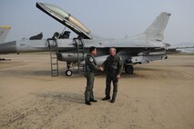 Republic of Korea Air Force Brig. Gen. Jung Jaebu, Air Force Operations Command vice commander, left, and Brig. Gen. Scott Dennis, 7th Air Force vice commander, shake hands in front of an ROK F-16 Fighting Falcon following a cross-command flight Oct. 21 during exercise Max Thunder 10-02 at Kwangju Air Base, ROK. General Jaebu flew in a U.S. Air Force F-16 while General Dennis flew in the ROK Air Force F-16 as a show of solidarity of the ROK-US alliance. (U.S. Air Force photo/Master Sgt. Jason Wilkerson)