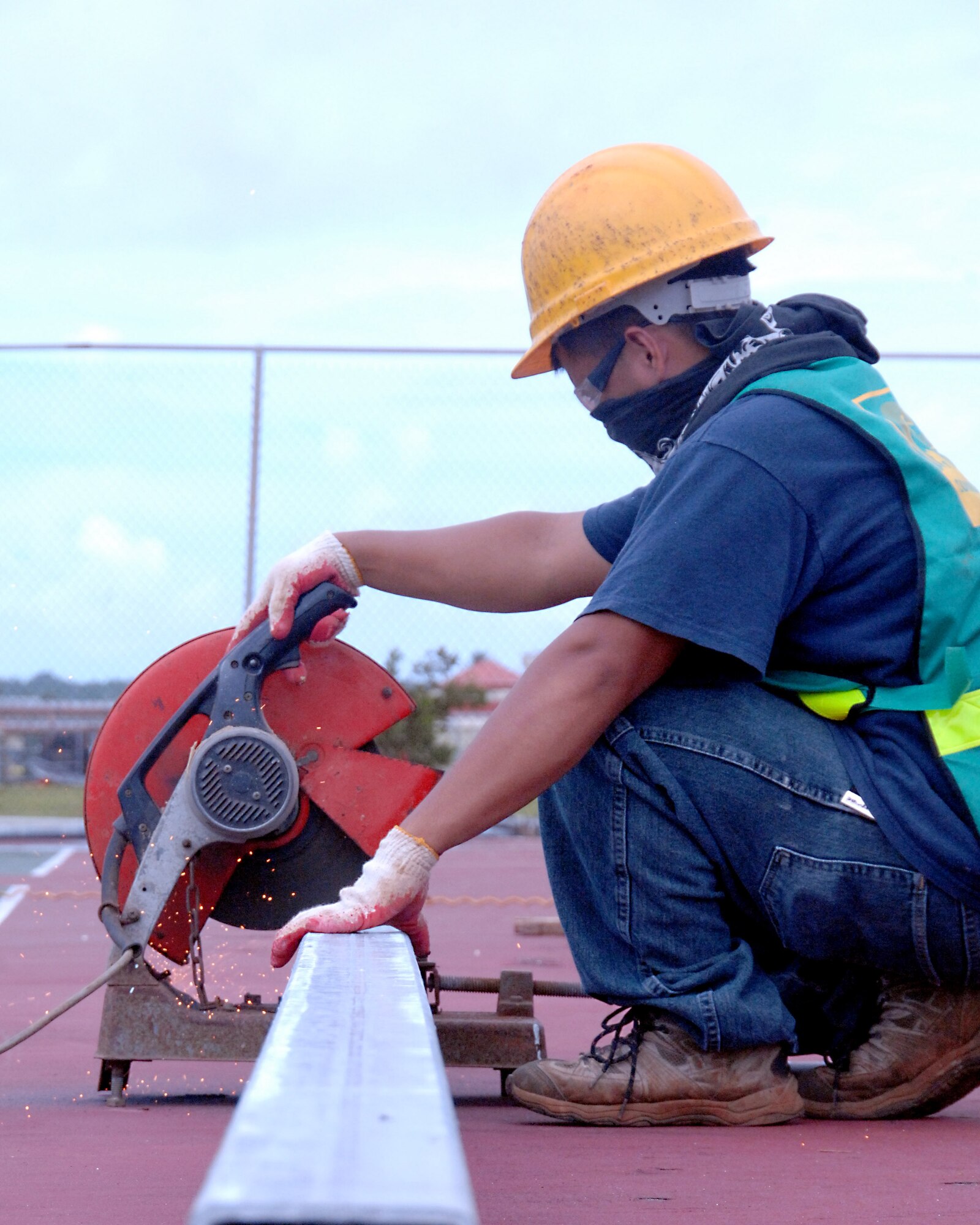 Richard Dizon, a local contractor, works on renovations for the tennis court across the street from the post office here Oct. 21. The tennis court is being remodeled as part of a base-wide quality-of-life improvement initiative. (U.S. Air Force photo/Airman Whitney Amstutz)