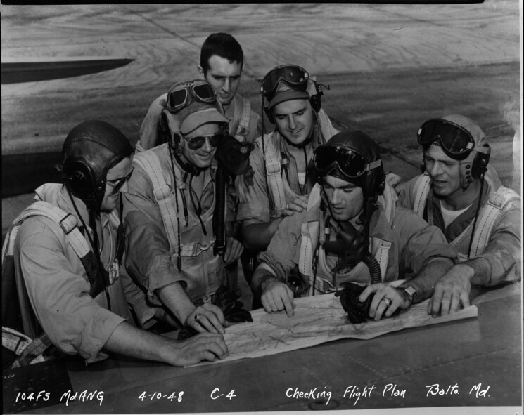 Maryland Air National Guard F-47 pilots assigned to the 104th Fighter Squadron discuss their flight plan at Baltimore Municipal Airport, April 10, 1948. (Released)