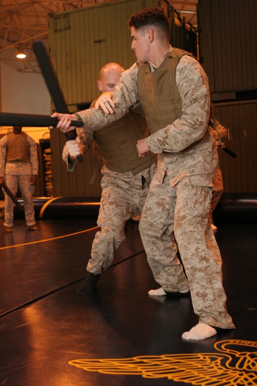Joseph H. El-smeirat and Brandon M. Chew, Marine Corps Martial Arts Instructors Course students, pull out their best techniques while free sparring during a class in the Marine Wing Support Squadron 171 warehouse here Oct. 25.