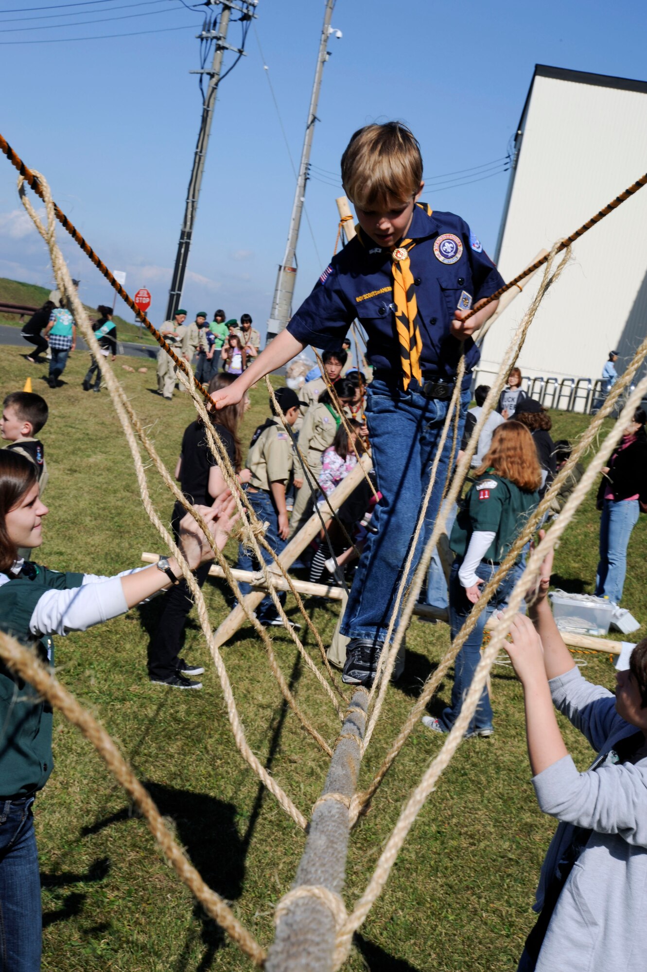 Thomas Alley, of Boy Scout Troop 9, maintains his balance while navigating the rope bridge at Misawa Air Base, Japan, Oct. 23, 2010.  The rope bridge was one of 24 activity stations for the scouts to participate in at International Scout Day. (U.S. Air Force photo by Tech. Sgt. Russell McBride/Released)