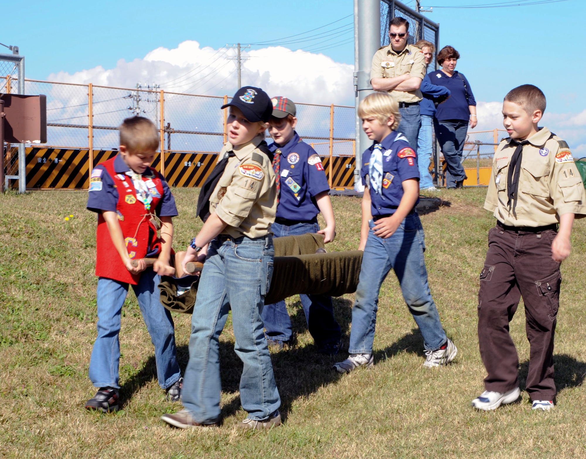 Members of the Boy Scouts of America move a litter patient to demonstrate their first-aid skills during the International Scout Day at Misawa Air Base, Japan, Oct. 23, 2010. Approximately 200 Boy and Girl Scouts from Misawa Air Base and 600 Japanese Boy and Girl Scouts attended this year's event. (U.S. Air Force photo by Tech. Sgt. Russell McBride/Released)