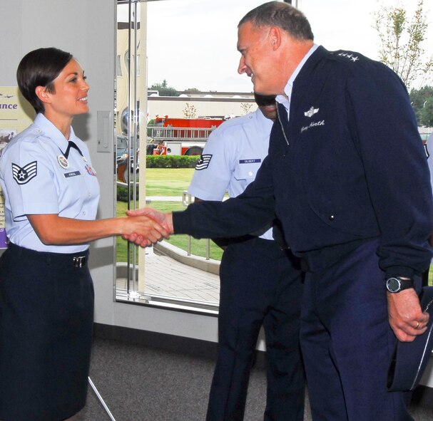YOKOTA AIR BASE, Japan -- General Gary North shakes hands with Tech. Sgt. Sherrill O'Neal at the Professional Development Center Oct. 25 during his tour of Yokota Air Base. Gen. North is the commander of the Pacific Air Force. (U.S. Air Force photo/Airman 1st Class Lynsie Nichols)