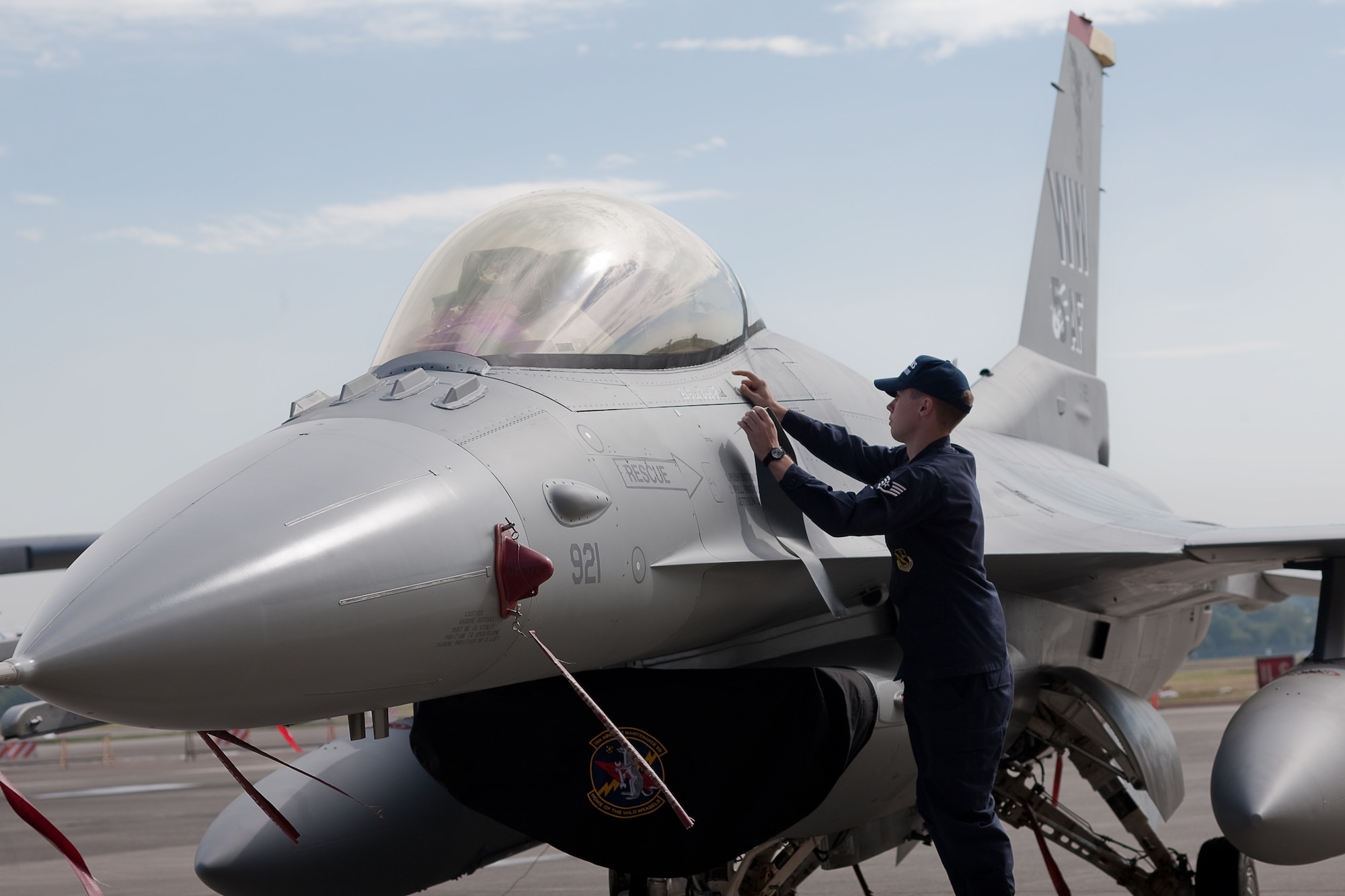YOKOTA AIR BASE, Japan -- Staff Sgt. Lucas Christensen, 374th Maintenance Squadron, reveals the name of the new United States Forces Japan and 5 AF commander Lt. Gen. Burton Field on the Fifth Air Force flagship during the change of command ceremony here Oct. 25. (U.S. Air Force photo/Osakabe Yasuo)