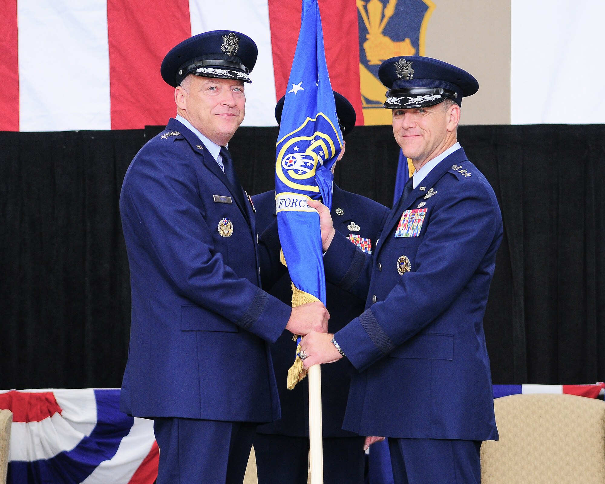 YOKOTA AIR BASE, Japan -- Lieutenant Gen. Burton Field (right), incoming United States Forces, Japan and Fifth Air Force commander, receives the 5 AF guidon from Gen. Gary North (left), Pacific Air Forces commander, during the change of command ceremony here, Oct. 25. (U.S. Air Force photo/Staff Sgt. Stacy Moless)