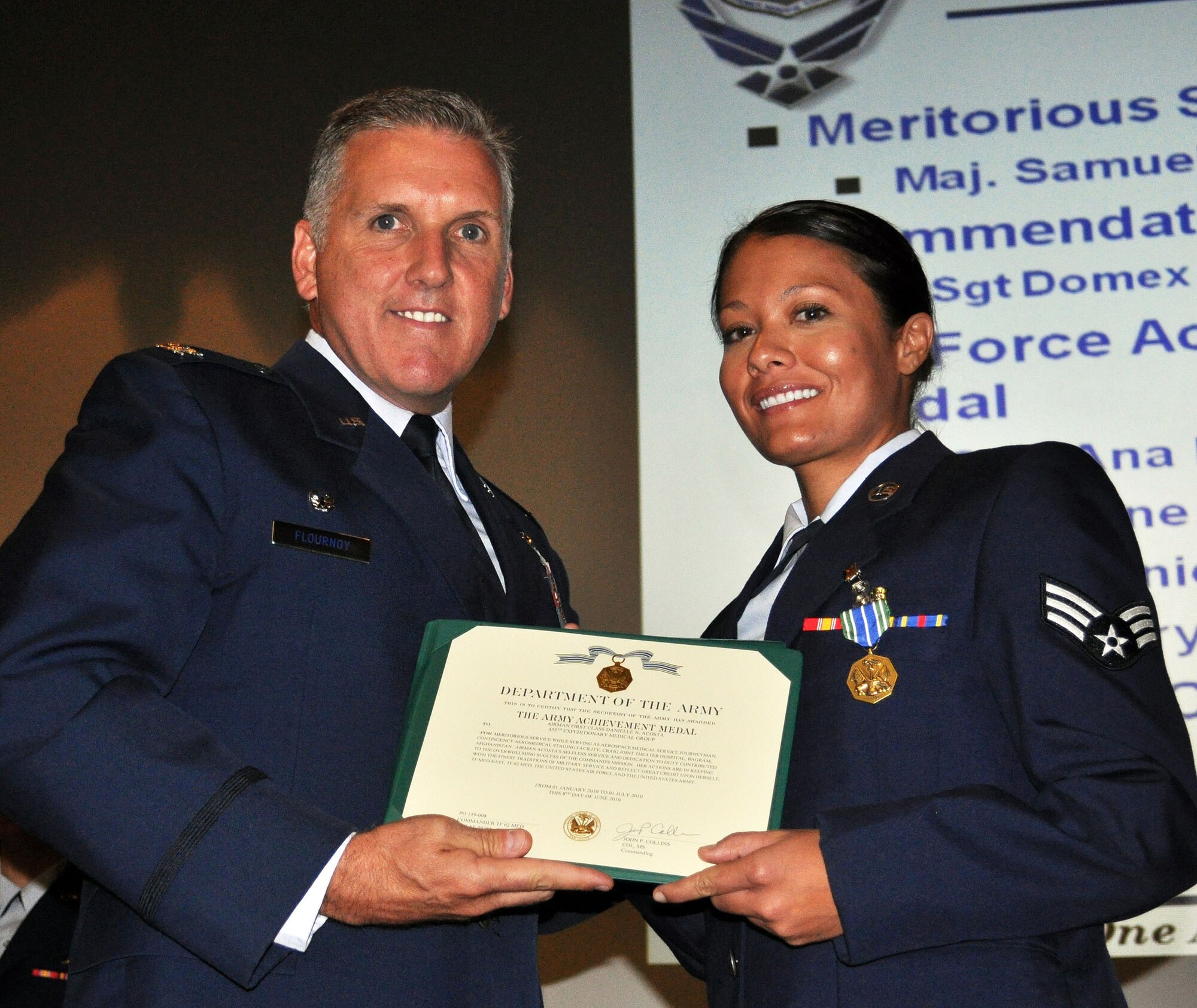 TRAVIS AIR FORCE BASE, Calif. -- Col. Jay Flournoy, wing commander, awards the U.S. Army Achievement medal to Senior Amn. Danielle Acosta, 349th Aeromedical Staging Squadron. (U.S. Air Force photo/Senior Master Sgt. Jeffrey Rachal) 