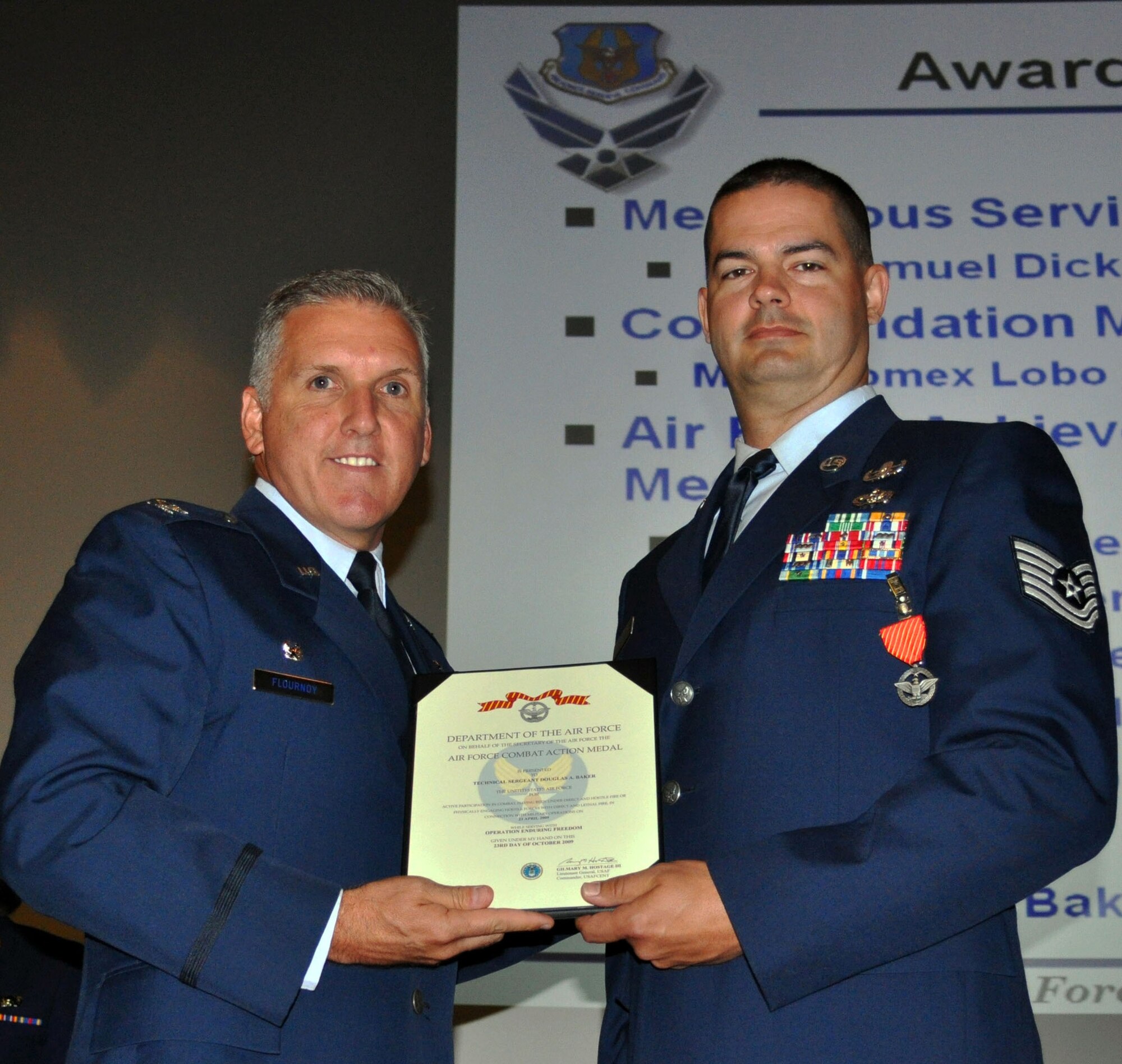 TRAVIS AIR FORCE BASE, Calif. -- Col. Jay Flournoy, wing commander, awards the Air Force Combat Action medal to Tech. Sgt. Doug Baker, 349th Civil Engineer Squadron, Explosive Ordinance Disposal specialist. (U.S. Air Force photo/Senior Master Sgt. Jeffrey Rachal) 