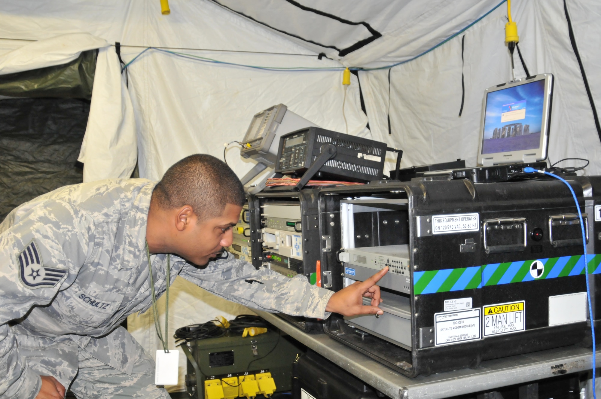 Staff Sgt. Daniel Schultz, 1st Combat Communications Squadron radio frequency transmissions systems supervisor, checks equipment on Campia Turzii Air Base, Romania. The 1st CBCS is responsible for setting up and maintaining all phone and computer systems for Operation Golden Lance, a partnership-building exercise conducted with the Romanian Air Force. (U.S. Air Force photo/Senior Airman David Dobrydney)