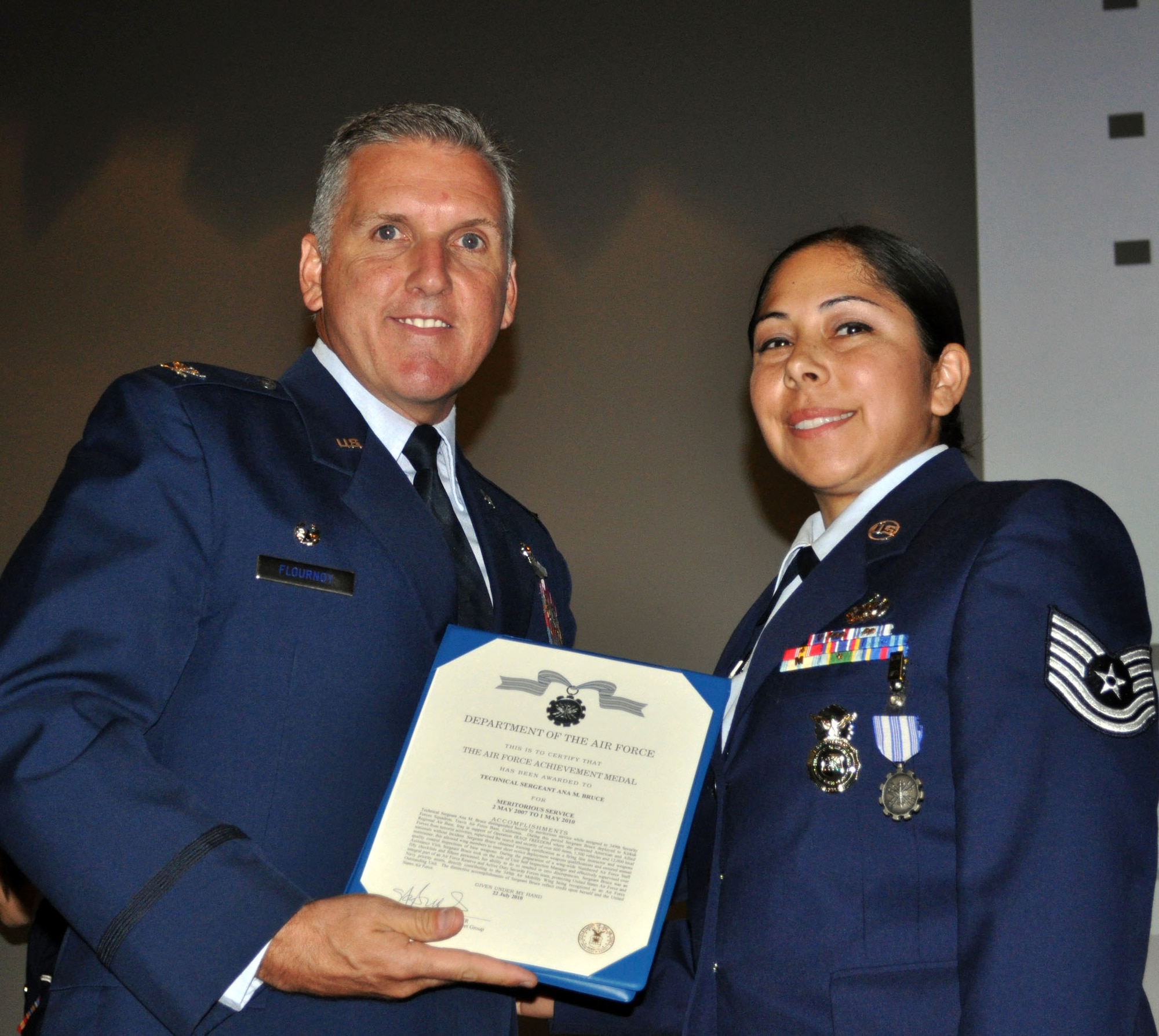 TRAVIS AIR FORCE BASE, Calif. -- Col. Jay Flournoy, wing commander, presented the Air Force Achievement medal to Tech. Sgt. Ana Bruce, 349th Security Forces Squadron, during a recent 349th Wing Commanders Call. (U.S. Air Force photo/Senior Master Sgt. Jeffrey Rachal) 