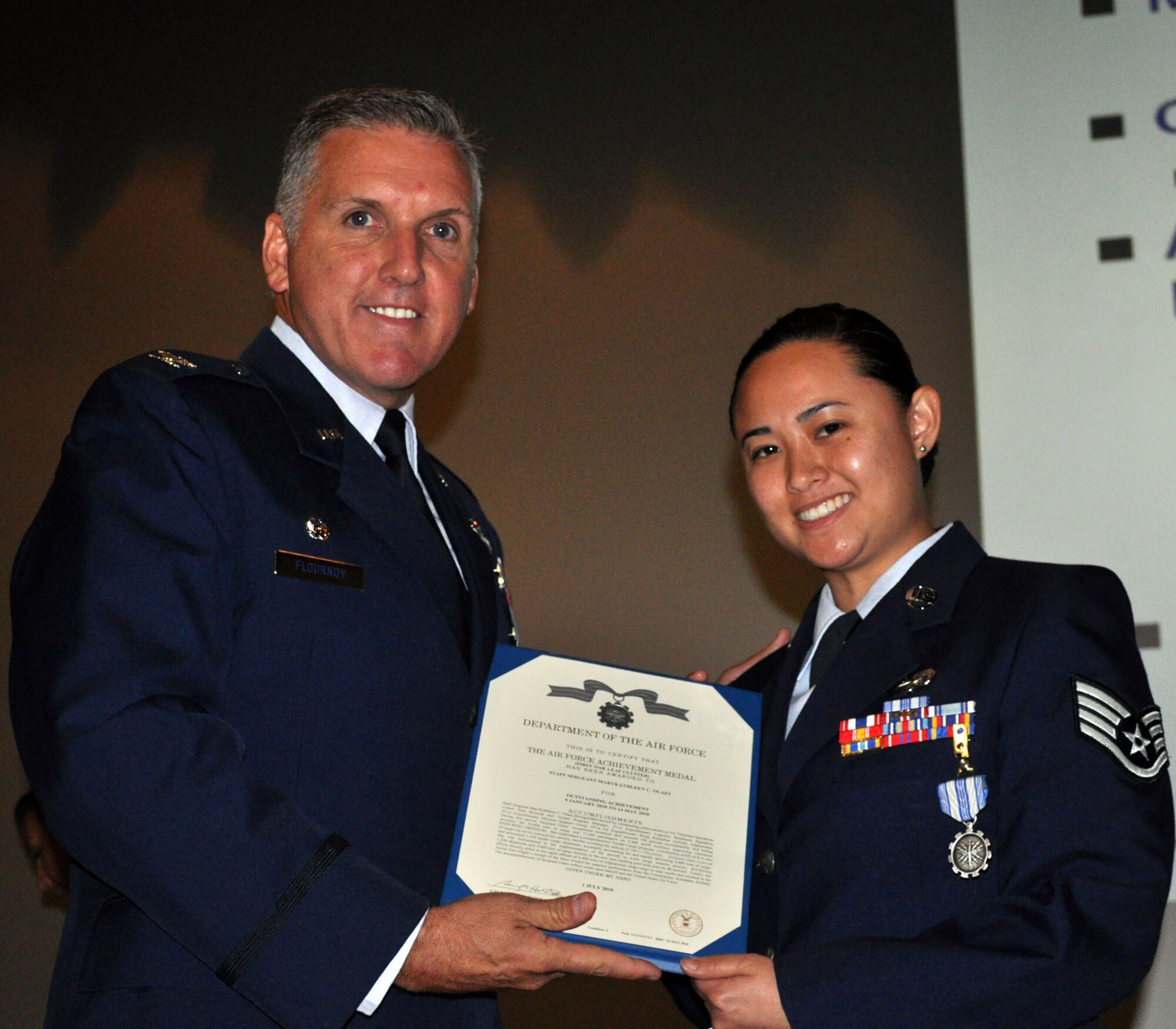 TRAVIS AIR FORCE BASE, Calif. -- Col. Jay Flournoy, wing commander, presented the Air Force Achievement medal to Staff Sgt. Mary Kathleen Olaes, 45th Aerial Port Squadron, during a recent Wing Commanders Call. (U.S. Air Force photo/Senior Master Sgt. Jeffrey Rachal)
