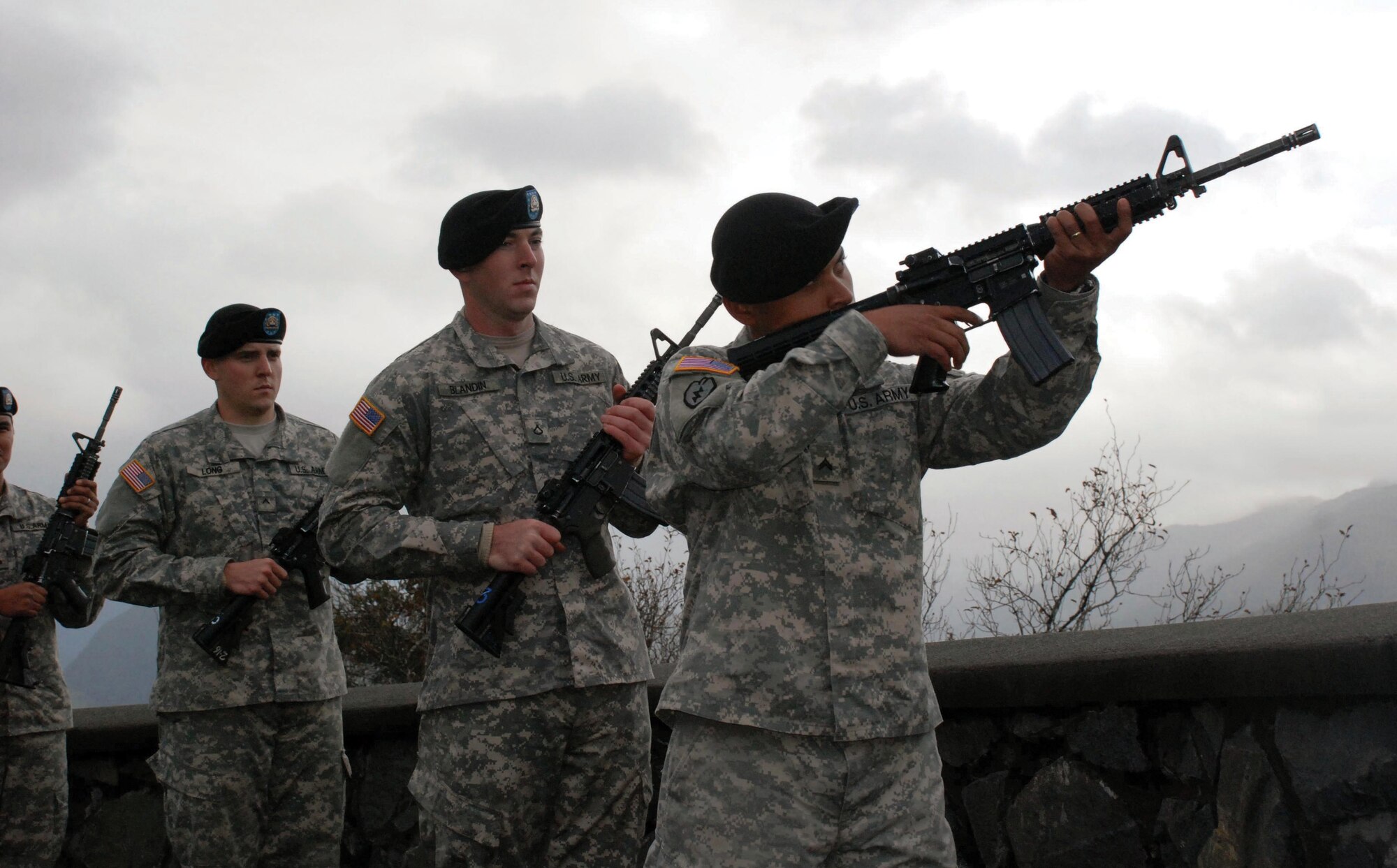Cpl. Atchumi Andreas, 1-25 SBCT, fires a shot during the roll call of states Monday at Castle Hill in Sitka, during the Alaska Day celebration. (U.S. Army photo/Mary Rall)