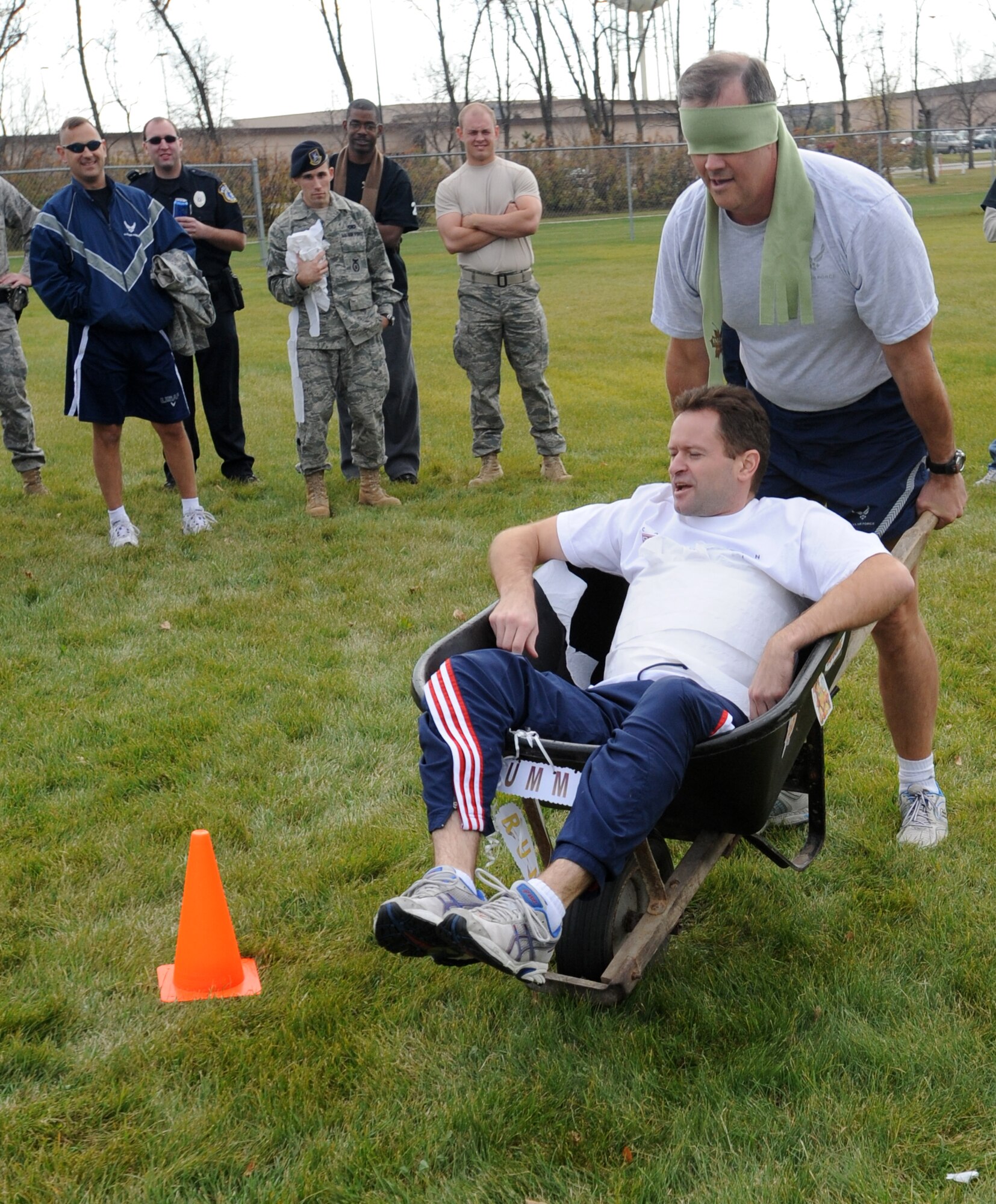Lt. Col. Brandon Hart (front), 319th Air Refueling Wing judge advocate, shouts out directions to Col. Don Shaffer, 319th Air Refueling Wing commander, during the mummy race Oct. 21 during Fall Fest on Grand Forks Air Force Base, N.D. In the mummy race, one teammate was wrapped up in an entire roll of toilet paper and the other teammate was blindfolded. The mummified teammate would shout out directions to the blindfolded teammate to navigate an obstacle course. Fall Fest included various events to boost the morale of servicemembers and their families. The 319th Operations Support Squadron won the grand prize drawing of $300. (U.S. Air Force photo by Staff Sgt. Suellyn Nuckolls)