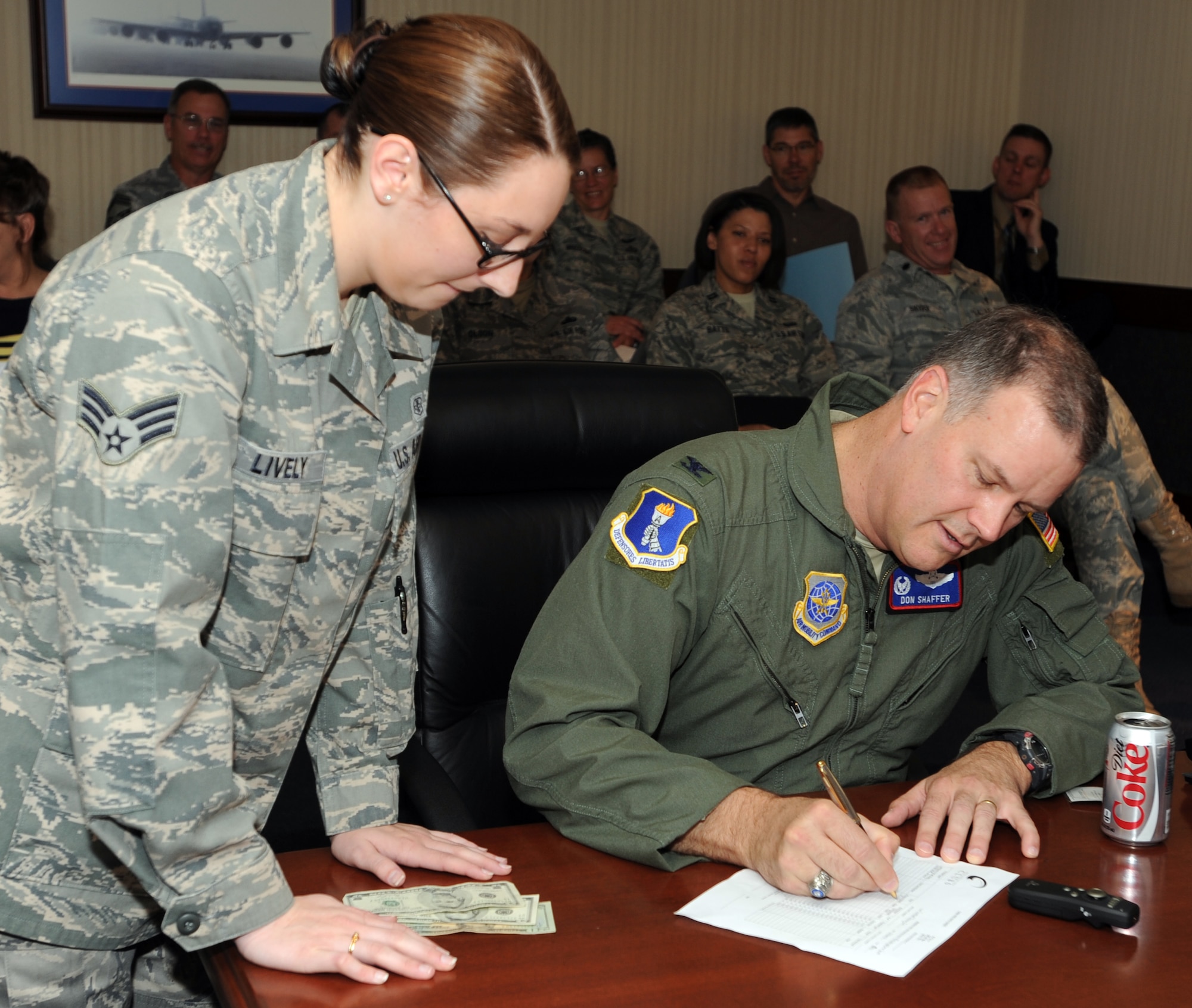 Col. Don Shaffer, 319th Air Refueling Wing commander, buys the first combat dining-in ticket from Senior Airman Lively, 319th Medical Group and Airman Activities Council president, during wing stand-up Oct. 20 at the wing’s command building on Grand Forks Air Force Base, N.D. The AAC will host the combat dining-in Nov. 10 beginning at 6 p.m. in Hanger 605. The event will include dinner, games and drinks. Tickets are on sale now. The cost of the tickets are as follows: E1 to E4 are $5, E5 to E6 are $8 and E7 and above are $12. The event is open to all active duty members.