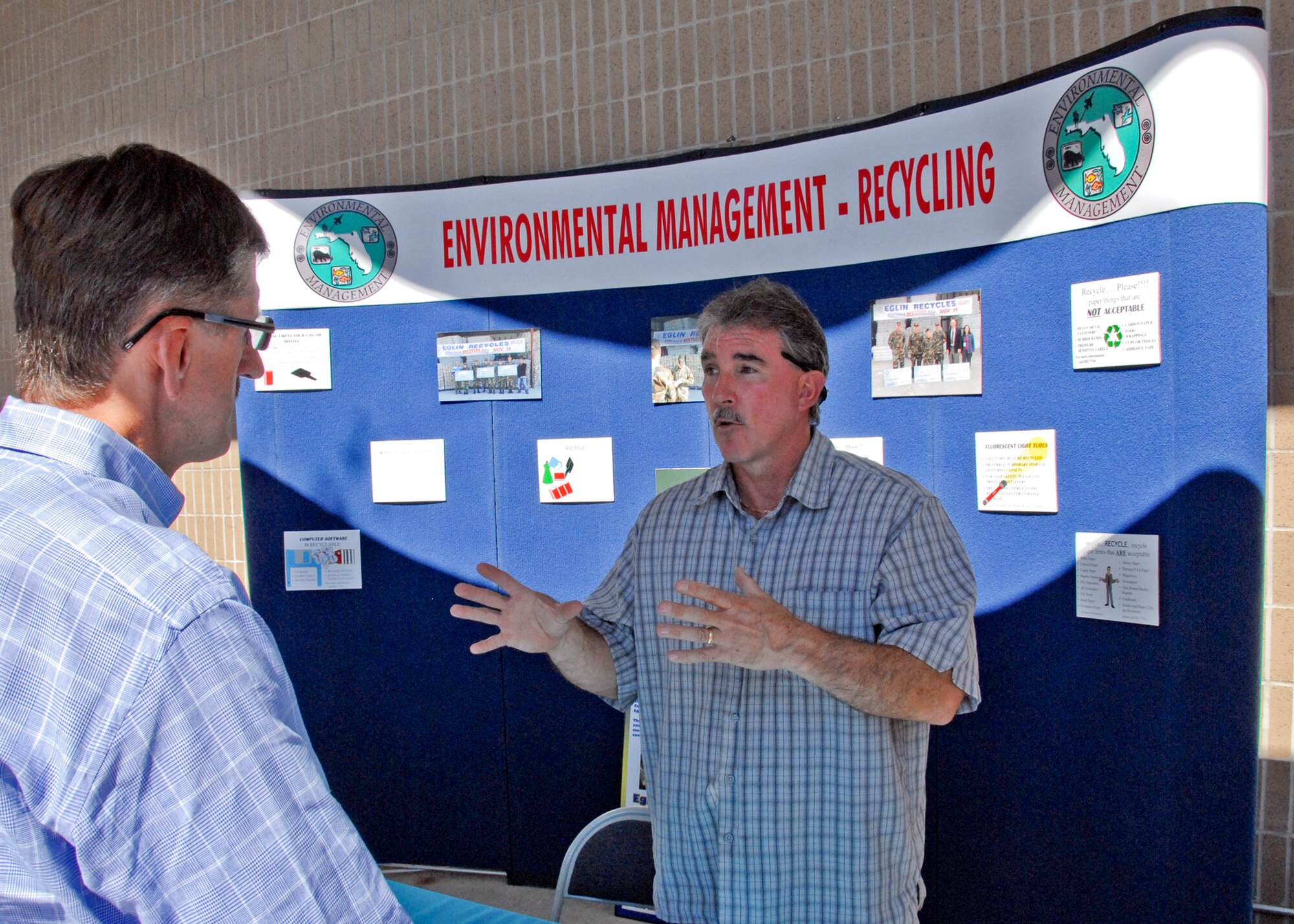 Mike Vannoy, Eglin Environmental Management office, talks about recycling with an attendee of the annual Energy Expo Oct. 21 at the base exchange.  The expo provided visitors a look at the future of energy use here and how to conserve energy. Eglin collaborated with several organizations for the event including Gulf Power, Choctawhatchee Electric Cooperative, Okaloosa Gas, Chevron Energy Solutions, the Okaloosa Building Industry Association and Eglin's Recycling Center. (U.S. Air Force photo/ Kevin Gaddie)