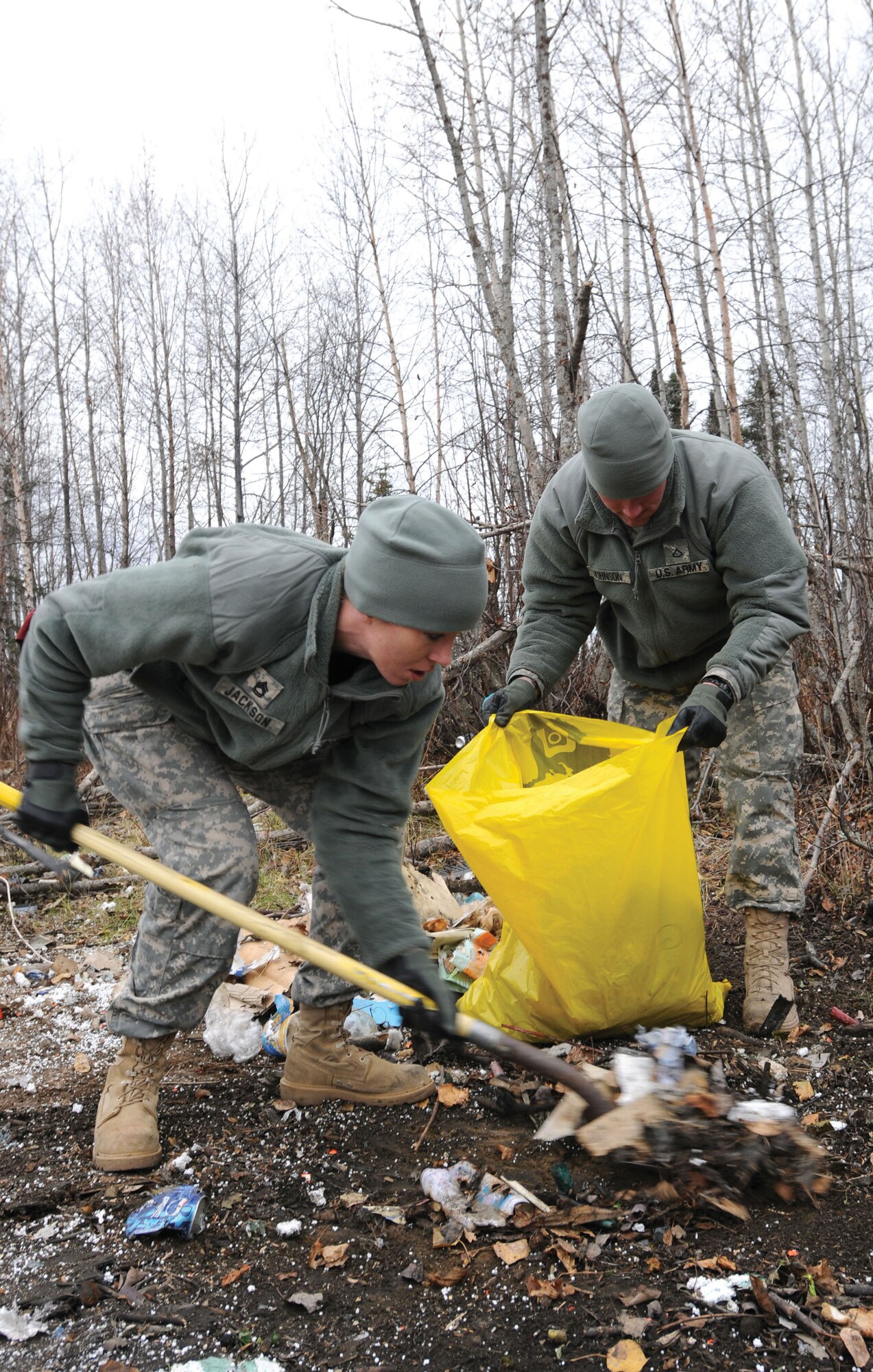 Sgt. 1st Class Elaine Jackson, Alaska Army National Guard Recruiting and Retention operations non-commissioned officer and Pfc. Ryan Johnson, AKARNG R&R Mobile Event Team Soldier, remove debris during operation “Guard the Environment” held at the Goose Bay State Game Refuge, Sunday. (U.S. ANG photo/Spc. Michelle Nash)