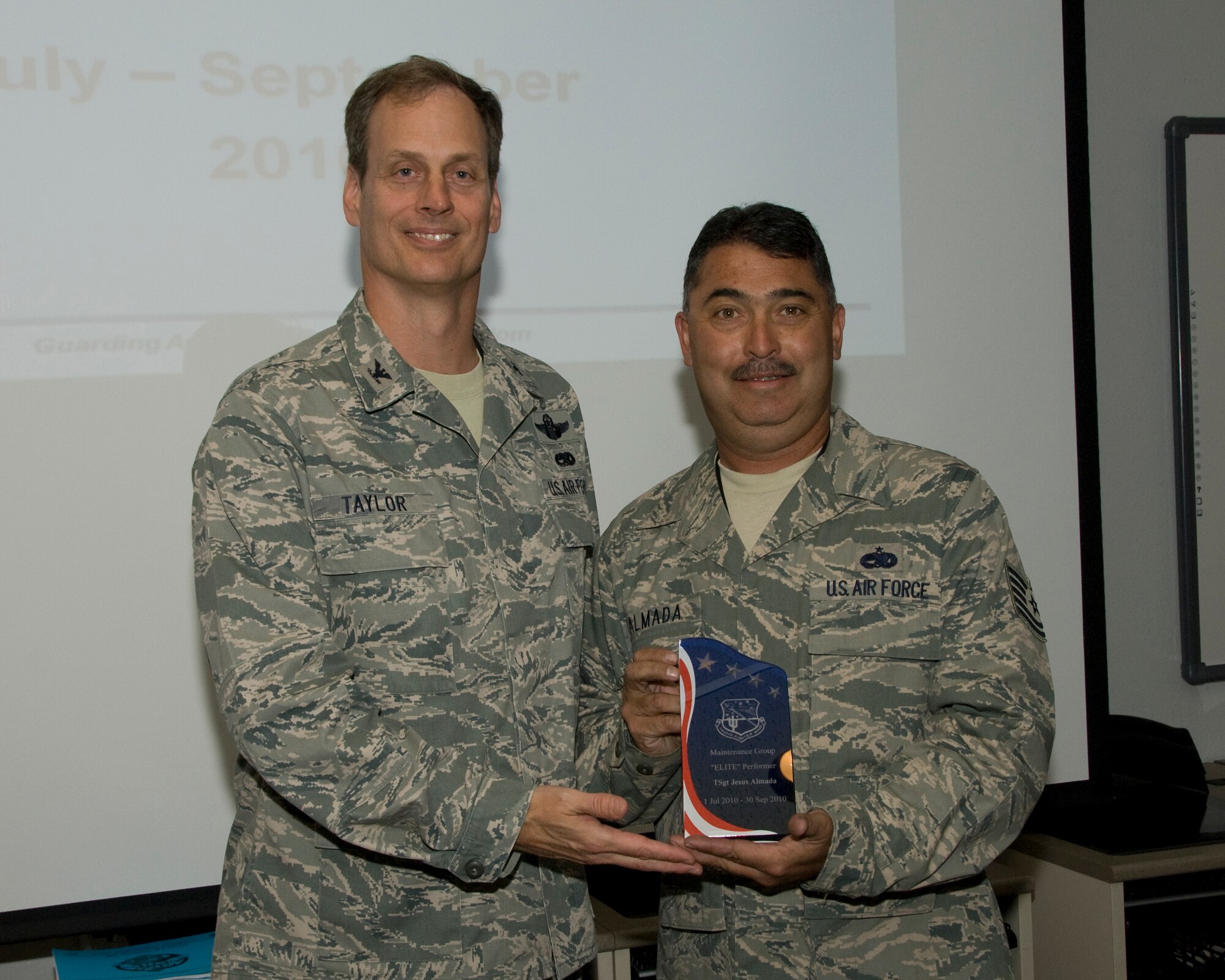 10/15/2010 – TUCSON, Ariz. -- Col. James Taylor, (Left) recognizes TSgt. Jesus Almada as the 162nd Maintenance Group Elite Performer for this quarter. The ceremony took place Oct 15. (Air Force photo by Master Sgt. David Neve)