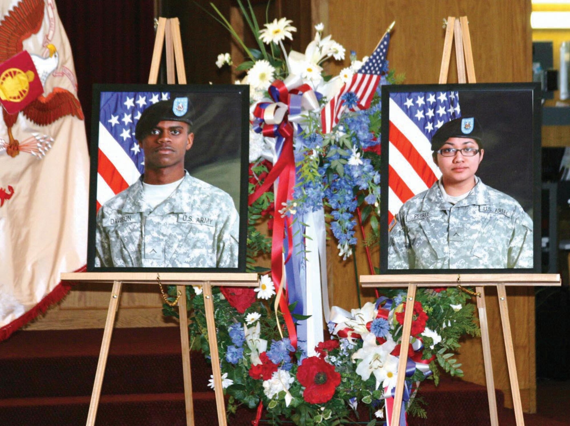 Photos of Pfc. William B. Dawson and Pfc. Jaysine P.S. Petree, 109th Transportation Company, 17th Combat Sustainment Support Battalion, at Soldiers’ Memorial Chapel, Oct. 12, during a ceremony in their honor. Dawson and Petree were killed in combat in Afghanistan, Aug. 24.  (U.S. Army Photo/Spc. Tamika Dillard)