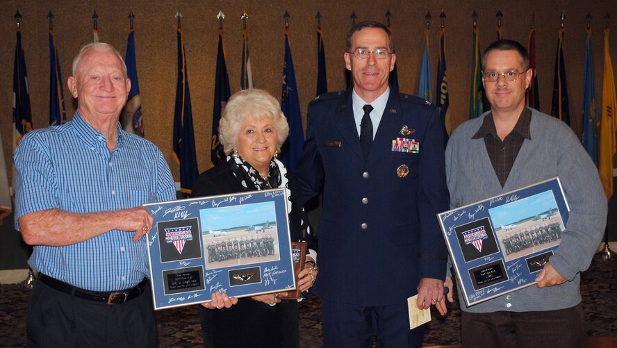 Col. George Ross, 14th Flying Training Wing vice commander, presents
Specialized Undergraduate Pilot Training Class 11-01's Pilot Partners, JoAnn
Ferguson, GNC at Leigh Mall, her husband Howard Ferguson; and Gerell Herron,
Army and Air Force Exchange Service, with a token of the classes
appreciation at their graduation breakfast Oct. 21 at Columbus AFB. Each
class is partnered with two business or civic organizations during their
year of training. This program is designed to foster closer ties between the
community and Columbus Air Force Base. In addition, each graduate was
presented a set of engraved pilot's wings provided by the pilot partners.
(U.S. Air Force photo/Staff Sgt. Jacob Corbin). 
