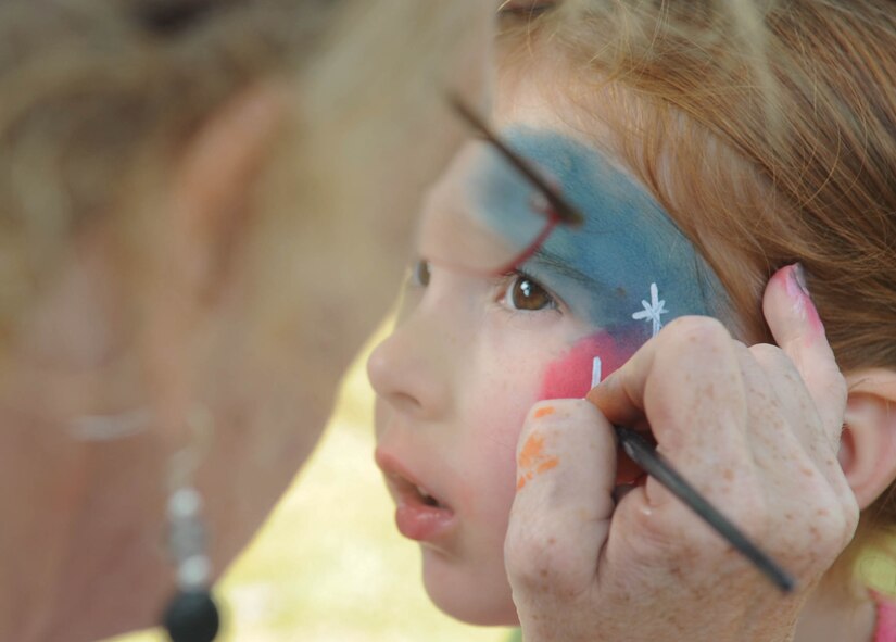 BARKSDALE AIR FORCE BASE, La. -- Kathryn Haddock, 3, gets her face painted by Ellen Williams, Clown Town USA during the 14th annual Celebrate Barksdale Oct. 22 hosted by the Military Affairs Council. The main event, a base-wide picnic, took place on the lawn of Chapel 1 where food and drinks were served. Kathryn is the daughter of Lt. Col. Mike Haddock, 2nd Mission Support Group deputy commander. (U.S. Air Force photo/Senior Airman Alexandra Boutte) (RELEASED)