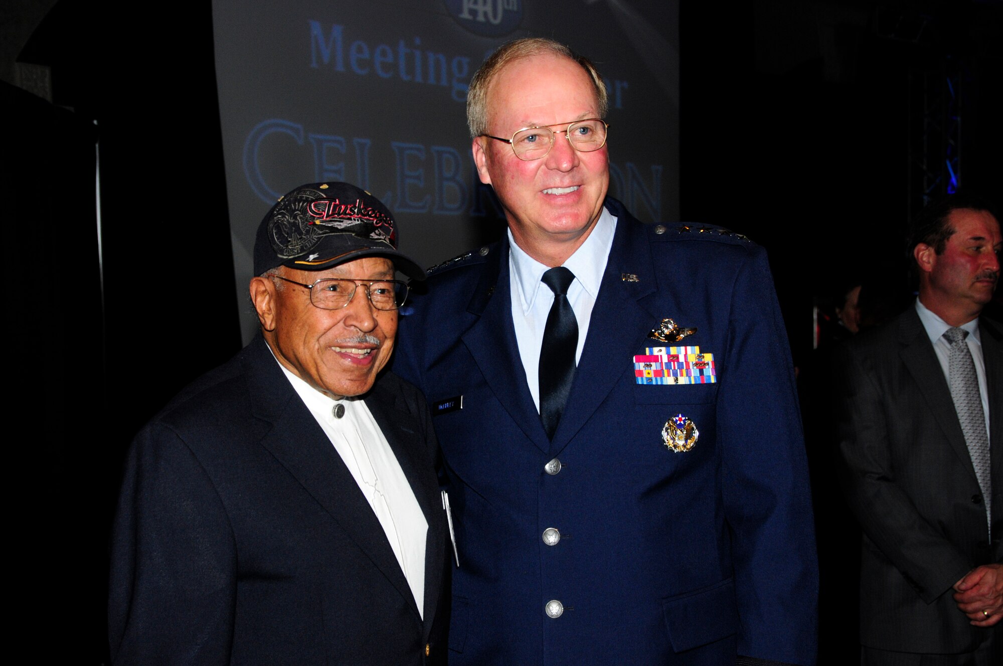 General Craig McKinley, chief of the National Guard Bureau, and former Tuskegee Airman and Pilot, Major Joe Gomer, pose for a photo together while at the annual Chamber of Commerce Dinner and Gala held on Oct. 21, 2010 at the Duluth Entertainment and Convention Center in Duluth, Minn.  Gen. McKinley was the keynote speaker for the event and spoke highly of 148th accomplishments, and the communities' positive support of military members.  He also recognized Maj. Joseph Gomer, a Duluth resident in attendance who served as a fighter pilot with World War II's famed Tuskegee Airmen.    (U.S. Air Force photo by MSgt Ralph Kapustka)