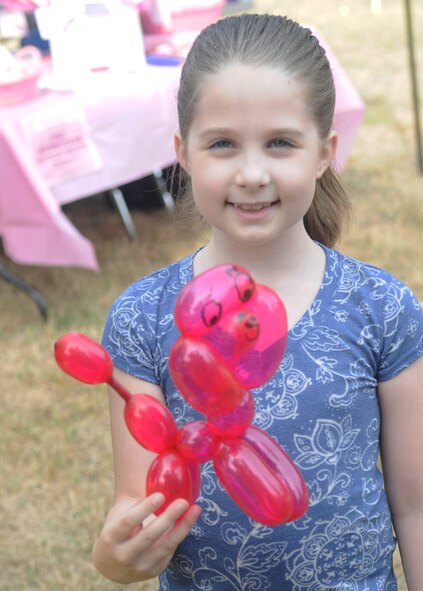 BARKSDALE AIR FORCE BASE, La. -- Raegan LeFors,7, shows a balloon poodle that was crafted by the clown at the 14th annual Celebrate Barksdale Oct. 22. There were many booths set up including a children's play area and a face painting booth. The Military Affairs Council hosted the base-wide picnic. Raegan is the daughter of Staff Sgt. Robert LeFors, 2nd Aircraft Maintenance Squadron. (U.S. Air Force photo/Senior Airman Alexandra Boutte) (RELEASED)